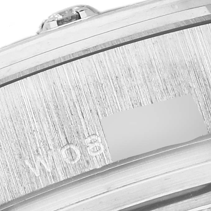 This image shows a close-up of the side part of a Rolex Pearlmaster 69319 Women
s White Gold Silver Dial 69319 Women
s White Gold Silver Dial watch, displaying part of its serial number engraved on the metal casing.