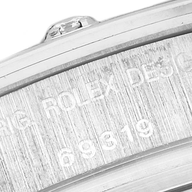 The image shows a close-up of the side and edge of a Rolex Pearlmaster 69319 Women
s White Gold Silver Dial 69319 Women
s White Gold Silver Dial watch case, highlighting the engraved model information.