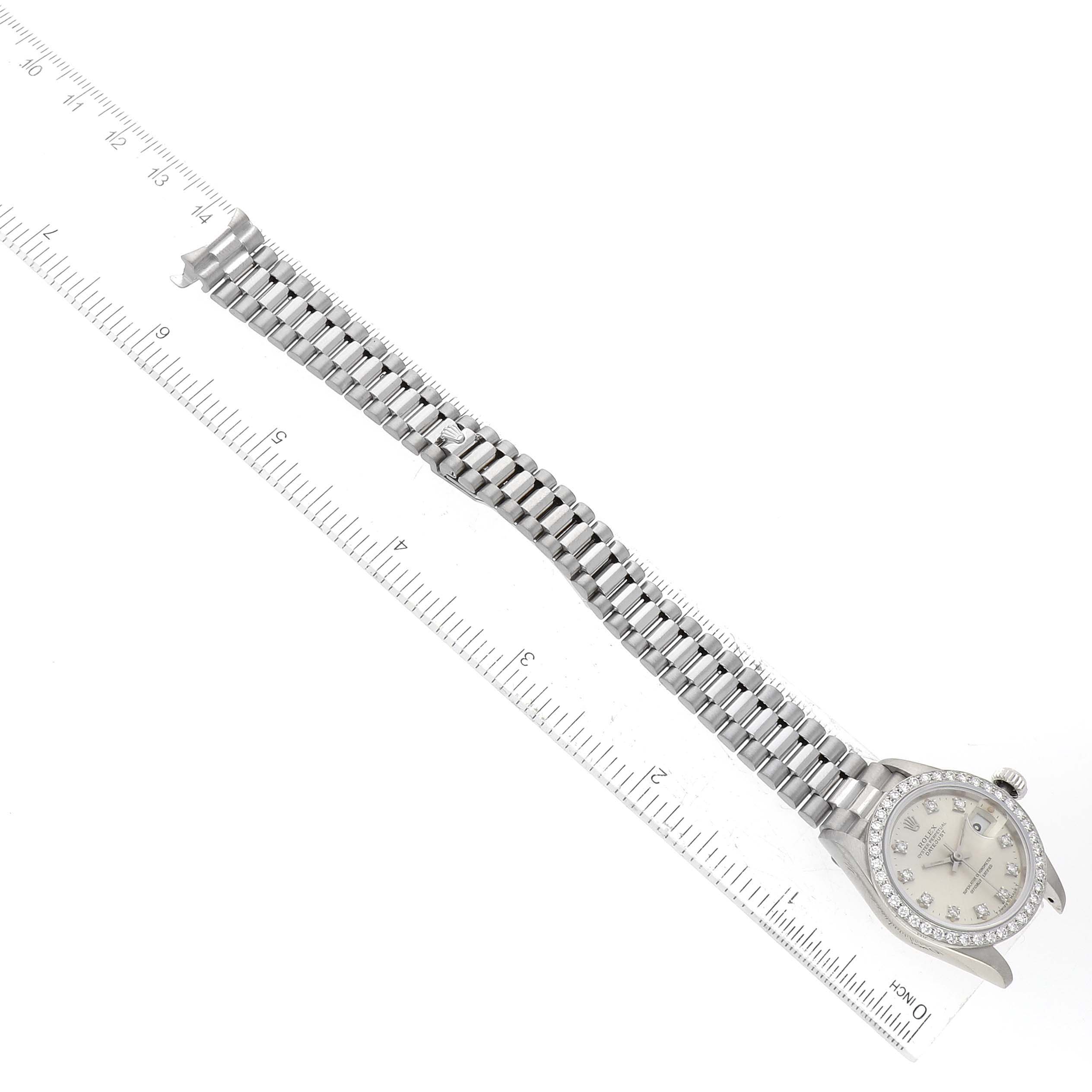 The image shows a Rolex President 69139 Women's White Gold Silver Dial 69139 Women's White Gold Silver Dial model watch laid flat, displaying the bracelet, dial, and a ruler for size reference.