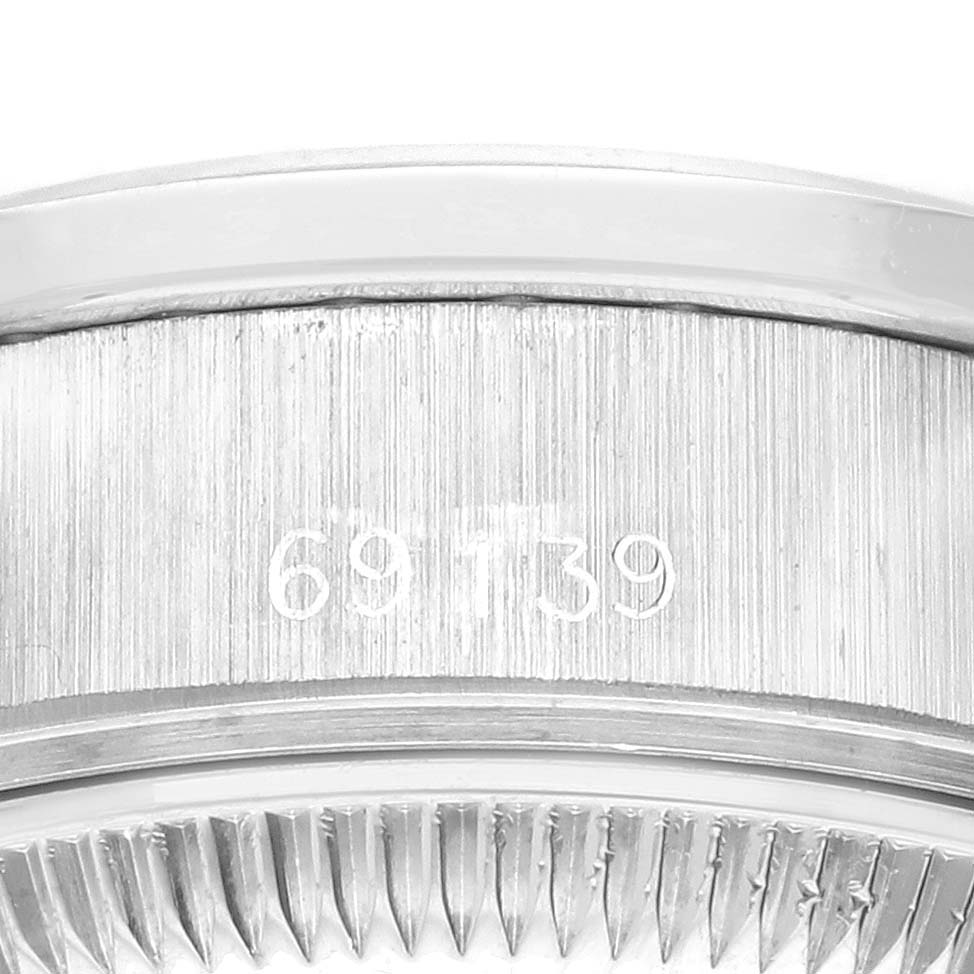The image shows a close-up of the serial number engraving on the side of a Rolex President 69139 Women's White Gold Silver Dial 69139 Women's White Gold Silver Dial model watch.