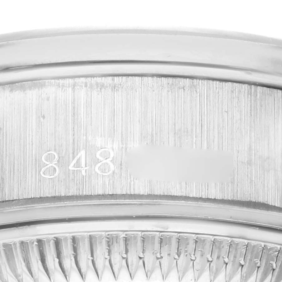 This image shows a close-up of the serial number and part of the bezel of a Rolex President 69139 Women's White Gold Silver Dial 69139 Women's White Gold Silver Dial model watch.