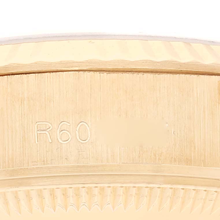 This close-up image shows the side engraving and bezel details of a Rolex President 69178 Women's Yellow Gold Black Dial 69178 Women's Yellow Gold Black Dial model watch.