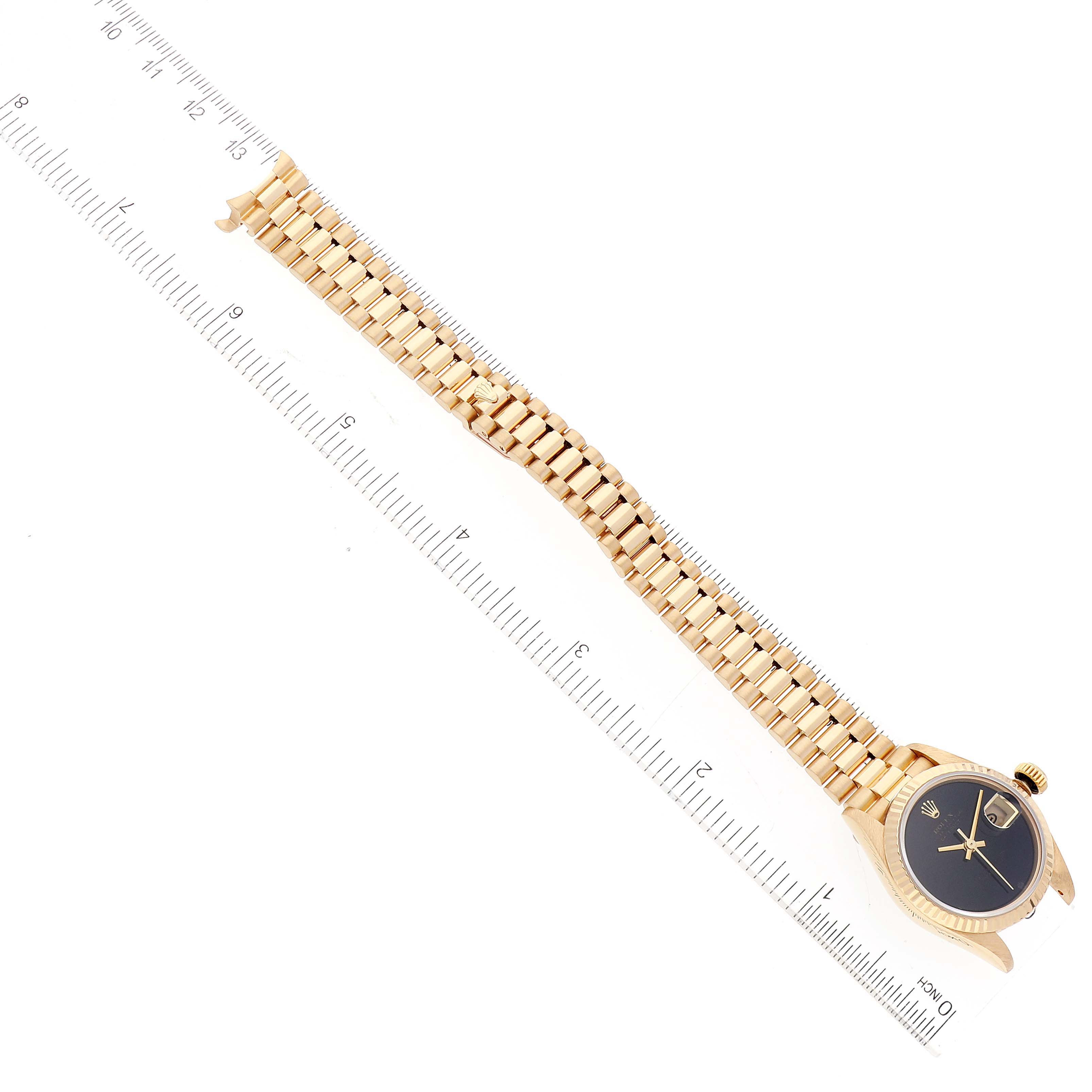 This image shows a Rolex President 69178 Women's Yellow Gold Black Dial 69178 Women's Yellow Gold Black Dial model watch from a top-down angle, highlighting the bracelet and face.