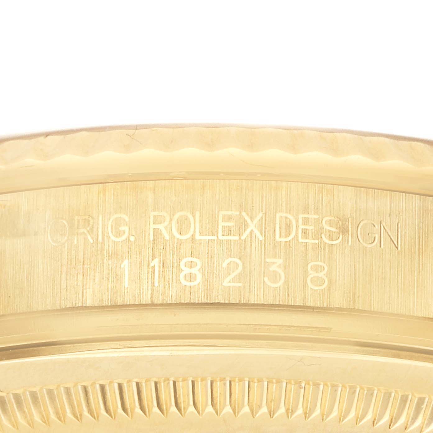 The image shows the engraved side of a Rolex President 118238 Men's Yellow Gold Champagne Dial model, highlighting its design and model number.