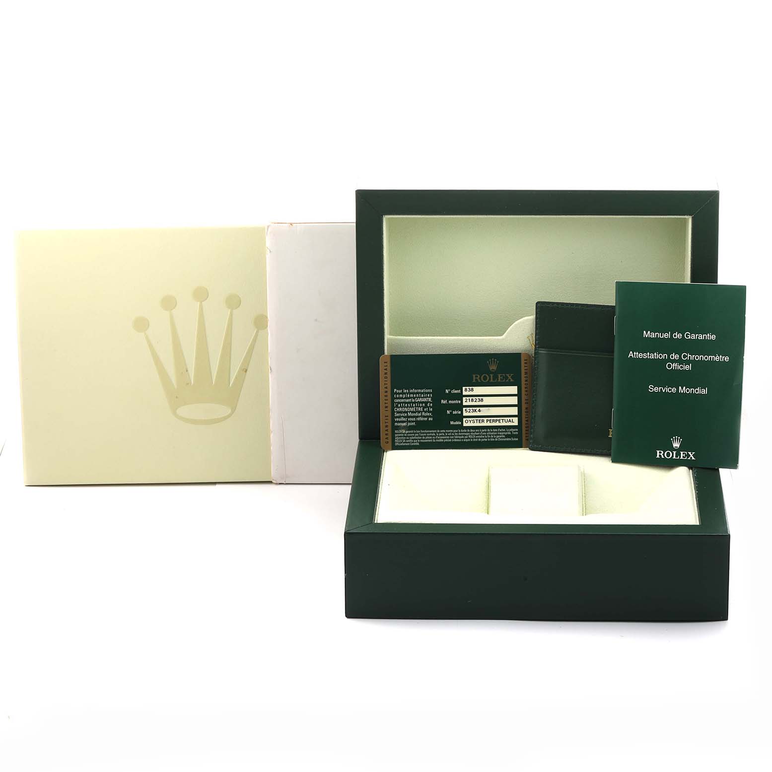 The image shows the packaging and accessories of a Rolex President 218238 Men's Yellow Gold Champagne Dial model, including the box, warranty manual, and cardholder, viewed from the front.