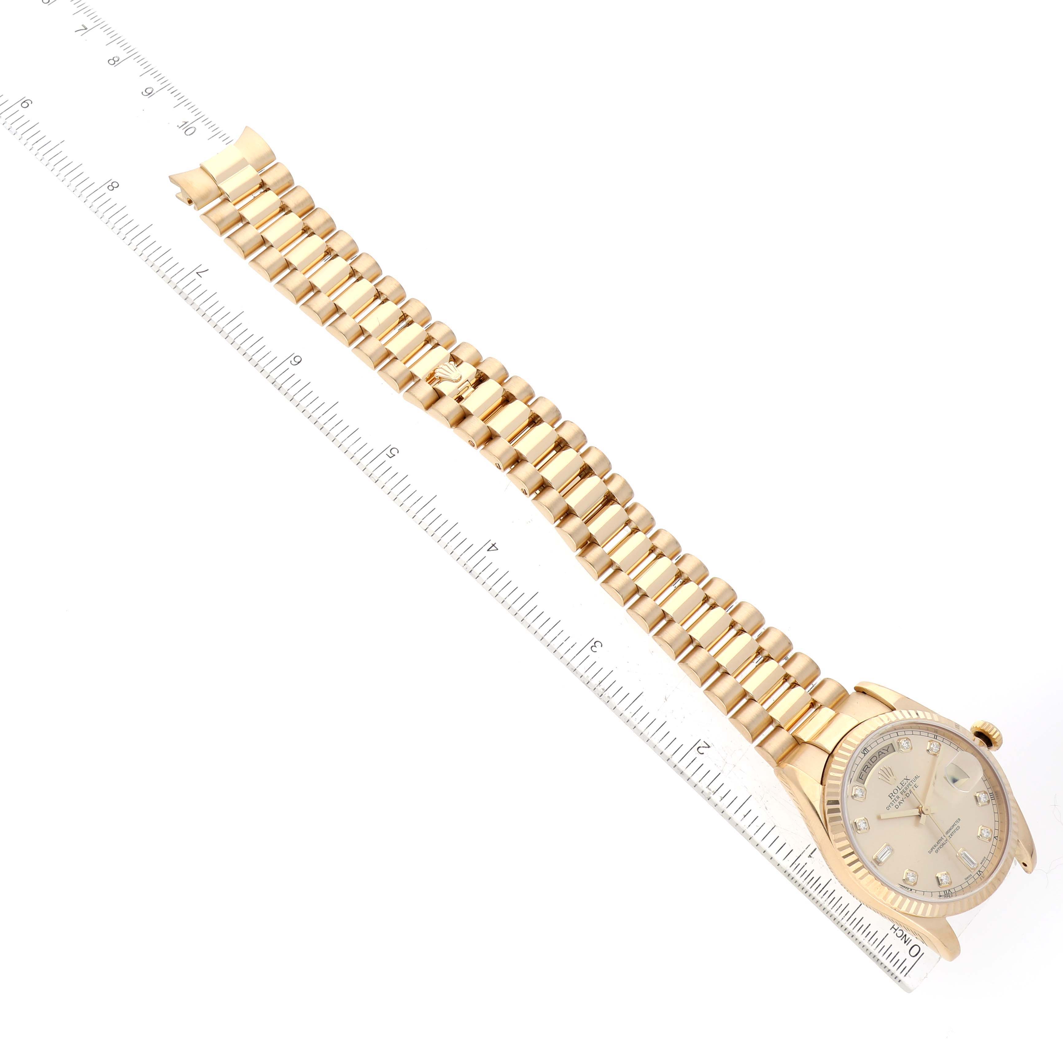 The image shows a Rolex President 118238 Men's Yellow Gold Champagne Dial 118238 Men's Yellow Gold Champagne Dial model watch laid flat with its crown, dial, and full bracelet visible, next to a measuring ruler.