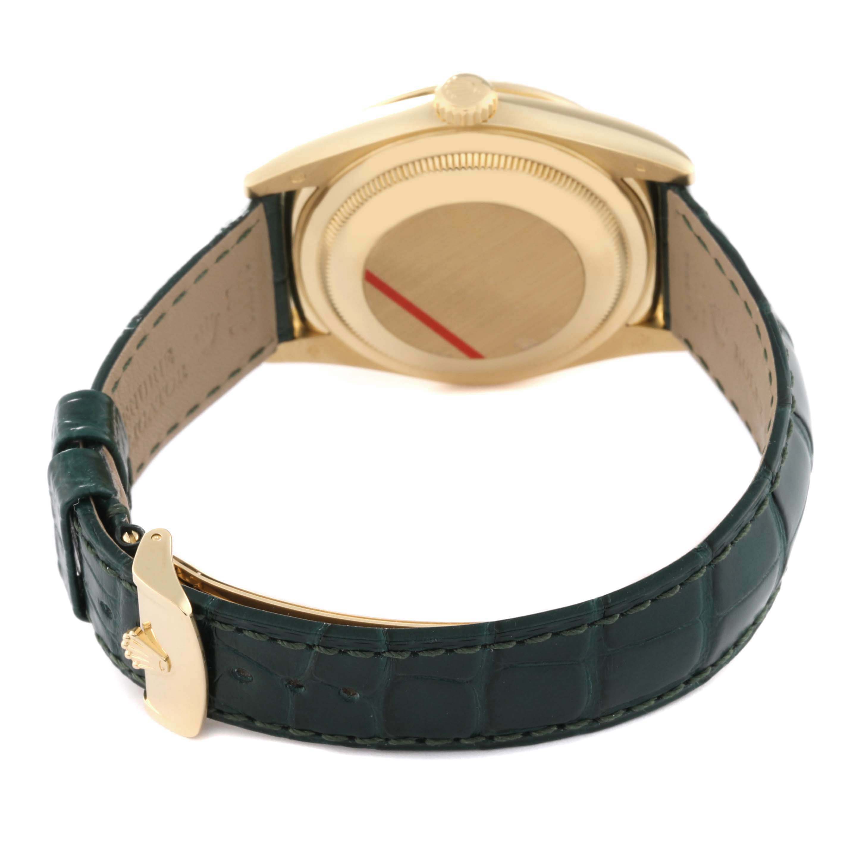 This image shows the rear view of a Rolex President 118138 Men
s Yellow Gold Green Dial 118138 Men
s Yellow Gold Green Dial model watch, including its green leather strap and gold-toned back case.