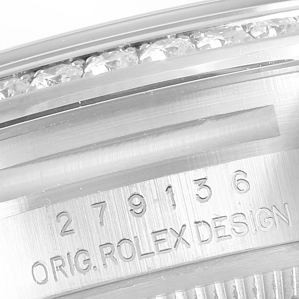 This image shows a close-up of the engraved serial number and diamond-studded bezel of the Rolex President 279136 Women's Platinum Blue Dial 279136 Women's Platinum Blue Dial model watch.