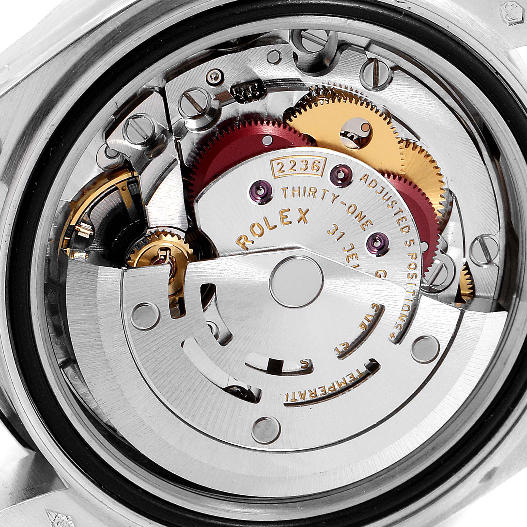 The image shows the internal mechanical movement of the Rolex President 279136 Women's Platinum Blue Dial 279136 Women's Platinum Blue Dial model watch, focusing on gears and intricate components.