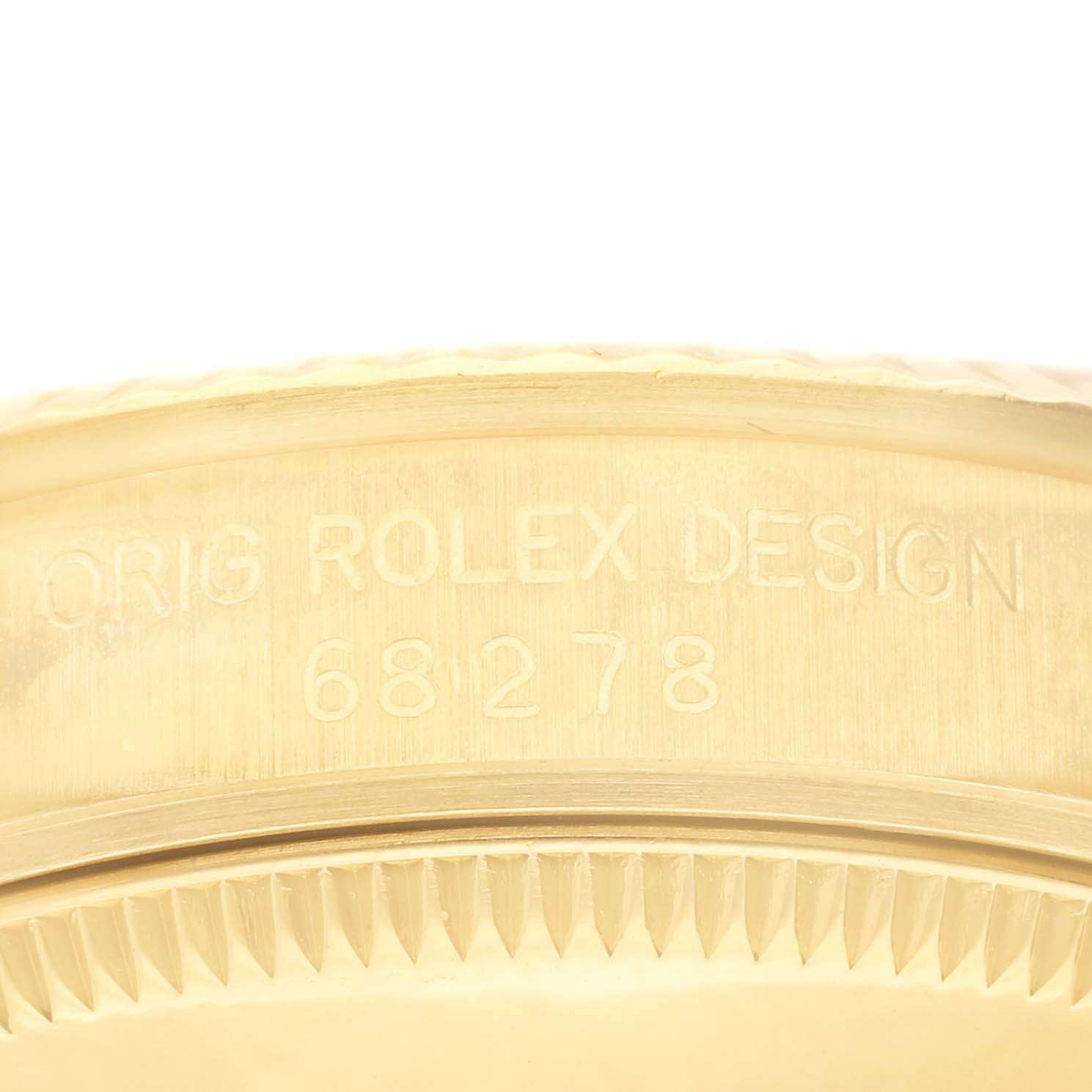 The image shows a close-up angle of the Rolex President 68278 Women's Yellow Gold Champagne Dial 68278 Women's Yellow Gold Champagne Dial model's case with visible serial number and design engraving.