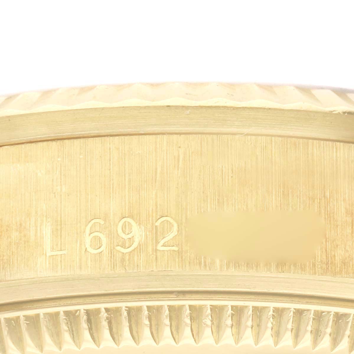 The image shows a close-up of the casing and fluted bezel edge of a Rolex President 68278 Women's Yellow Gold Champagne Dial 68278 Women's Yellow Gold Champagne Dial model watch, with visible serial numbers.