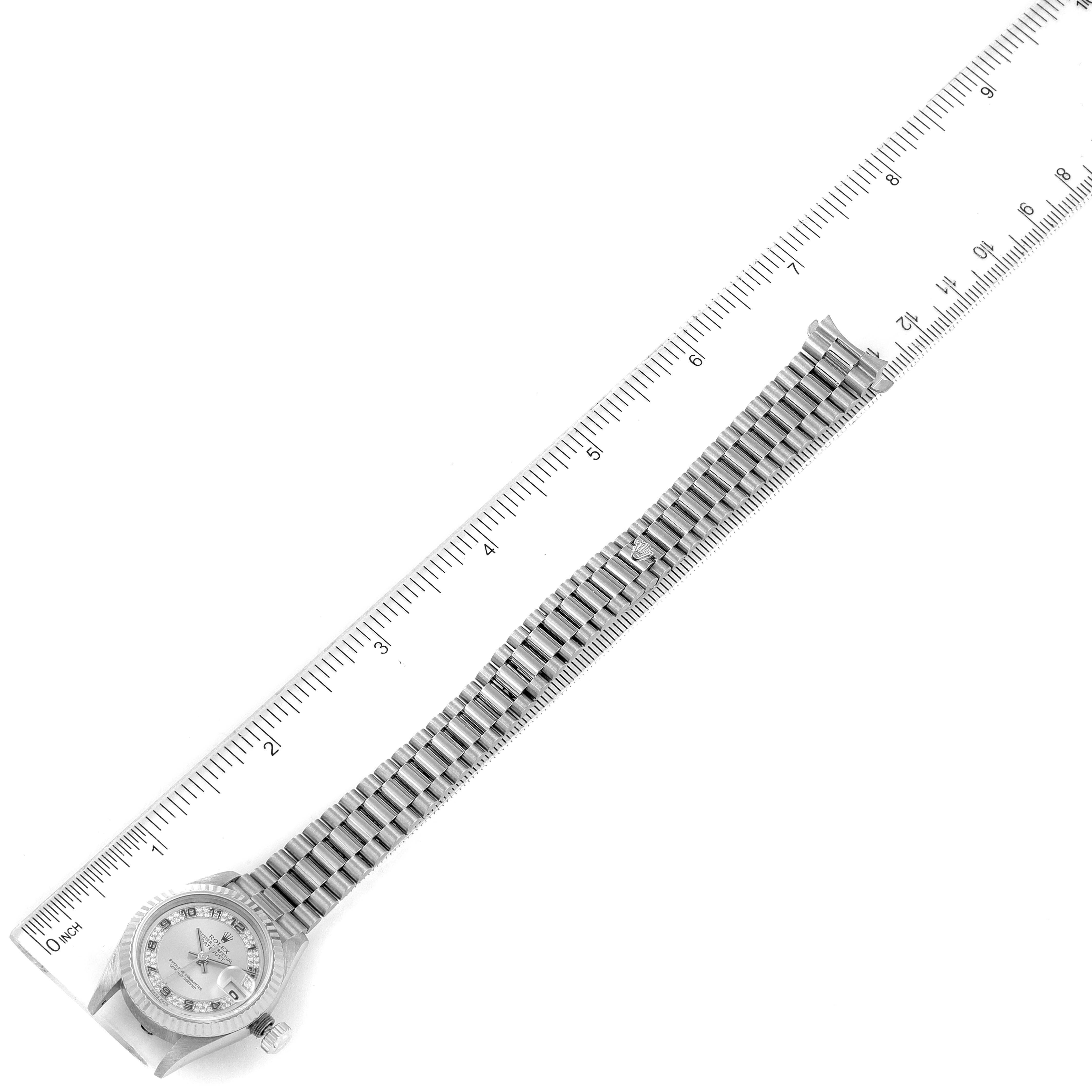 The image shows a top-down view of a Rolex President 69179 Women's White Gold Silver Dial 69179 Women's White Gold Silver Dial model watch with a ruler for scale, displaying the full bracelet and watch face.