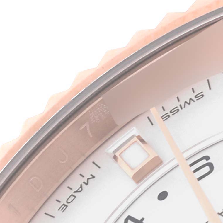The image shows a close-up of the bezel, partial dial, and date indicator of a Rolex Sky-Dweller 326135 Men's Rose Gold Silver Dial watch.