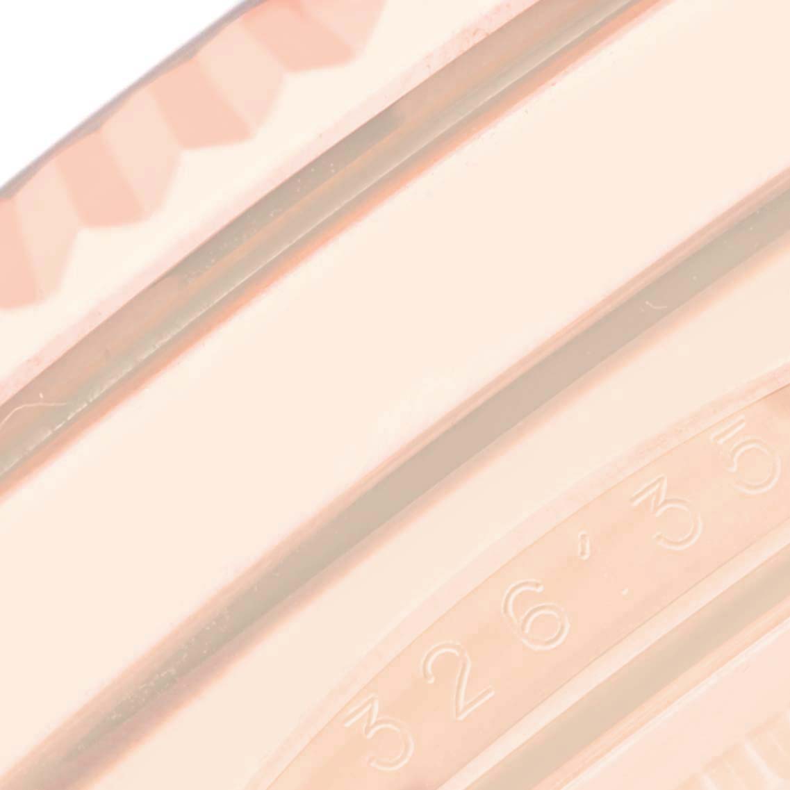 The image shows a close-up of the Rolex Sky-Dweller 326135 Men's Rose Gold Silver Dial's edge, featuring part of the bezel with numbers engraved.