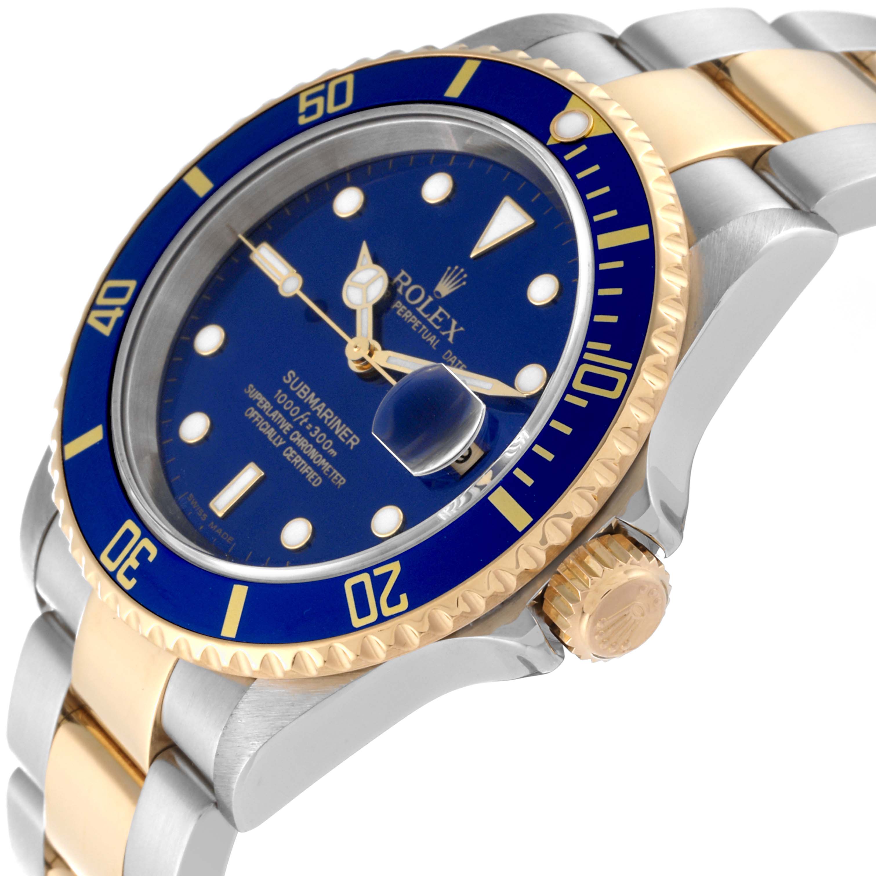 The image shows a Rolex Submariner 16613 Men's Steel and Gold (two tone) Blue Dial 16613 Men's Steel and Gold (two tone) Blue Dial watch at an angled close-up, focusing on the blue dial, bezel, gold crown, and two-tone bracelet.