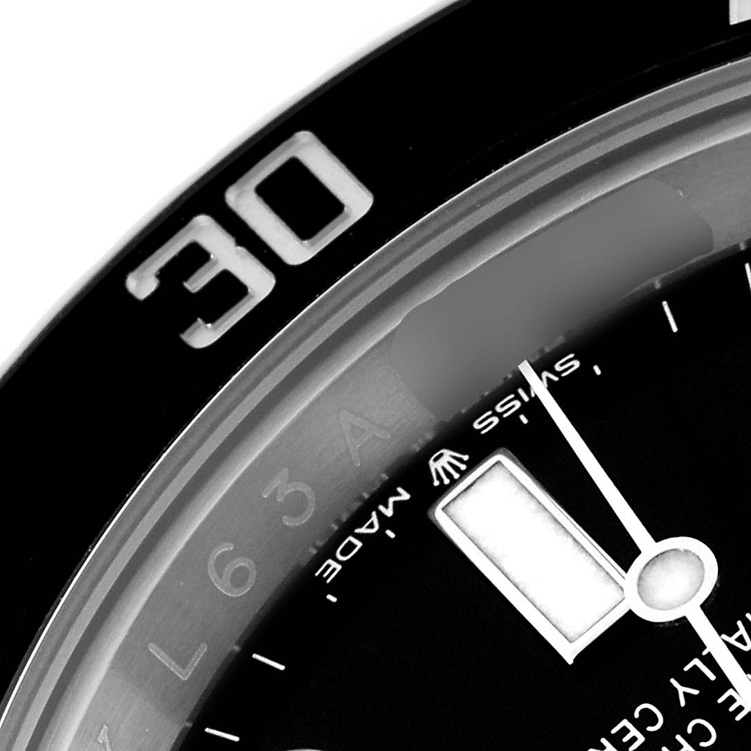 This is a close-up view of a Rolex Submariner 124060 Men's Stainless Steel Black Dial 124060 Men's Stainless Steel Black Dial watch, showing part of the bezel, dial, and minute hand.