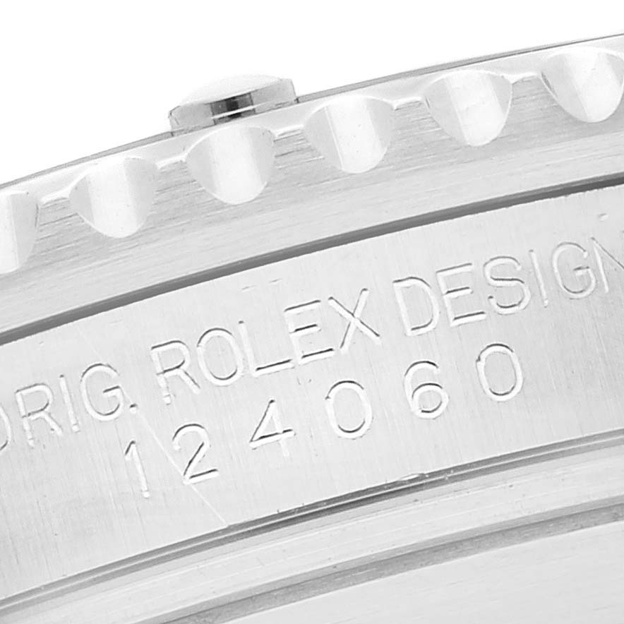 This image shows a close-up of the case back and part of the bezel of a Rolex Submariner 124060 Men's Stainless Steel Black Dial 124060 Men's Stainless Steel Black Dial model, with the engraving "Orig. Rolex Design 124060" visible.