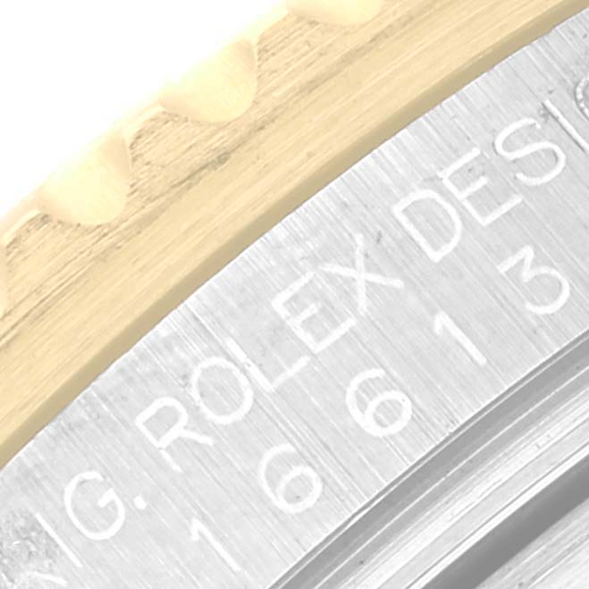 The image shows a close-up of the bezel and engraved serial number of a Rolex Submariner 16613 Men
s Steel and Gold (two tone) Black Dial 16613 Men
s Steel and Gold (two tone) Black Dial watch.