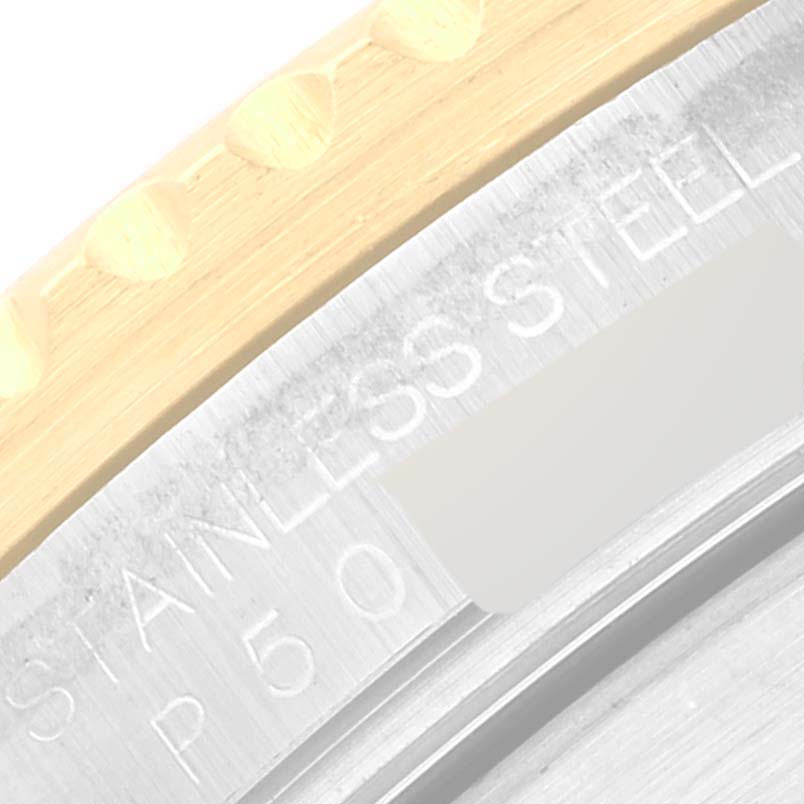 The image shows a close-up of the edge of the bezel and case back of a Rolex Submariner 16613 Men
s Steel and Gold (two tone) Black Dial 16613 Men
s Steel and Gold (two tone) Black Dial watch, highlighting the "STAINLESS STEEL" engraving.