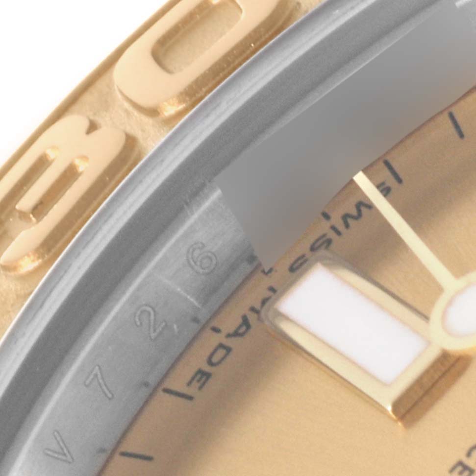 The image shows a close-up of the bezel, part of the dial, and the markers of a Rolex Yacht-Master 168623 Men's Steel and Gold (two tone) Champagne Dial 168623 Men's Steel and Gold (two tone) Champagne Dial watch.