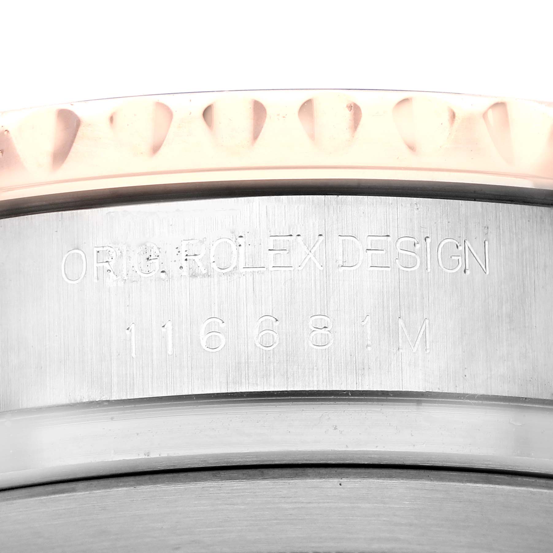 This image shows a close-up of the engraved side of the case of a Rolex Yacht-Master 116681 Men's Steel and Gold (two tone) White Dial 116681 Men's Steel and Gold (two tone) White Dial model, highlighting the serial number.