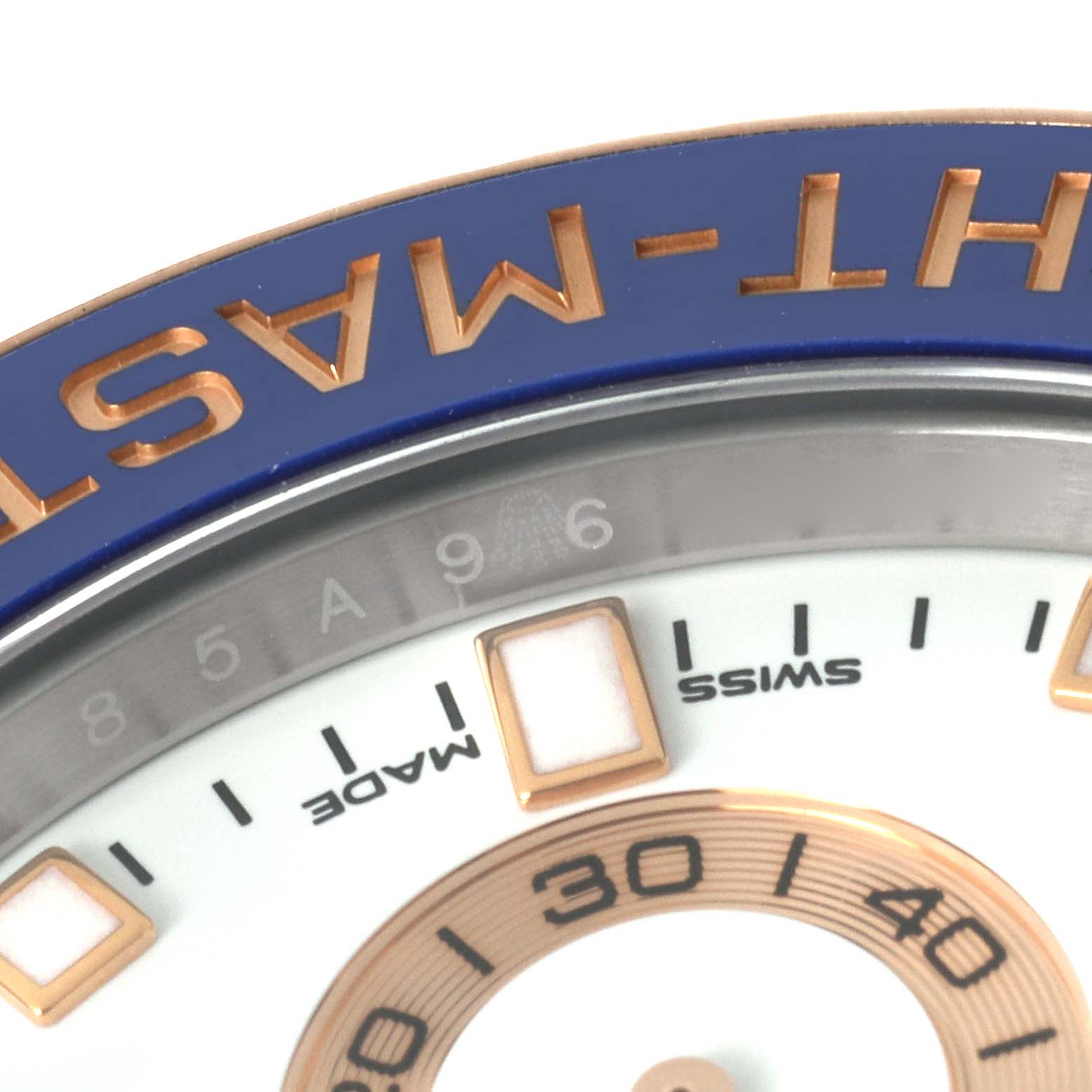 The image shows a close-up of the dial and bezel of a Rolex Yacht-Master 116681 Men's Steel and Gold (two tone) White Dial 116681 Men's Steel and Gold (two tone) White Dial watch, focusing on the "SWISS MADE" text and part of the minute markers.