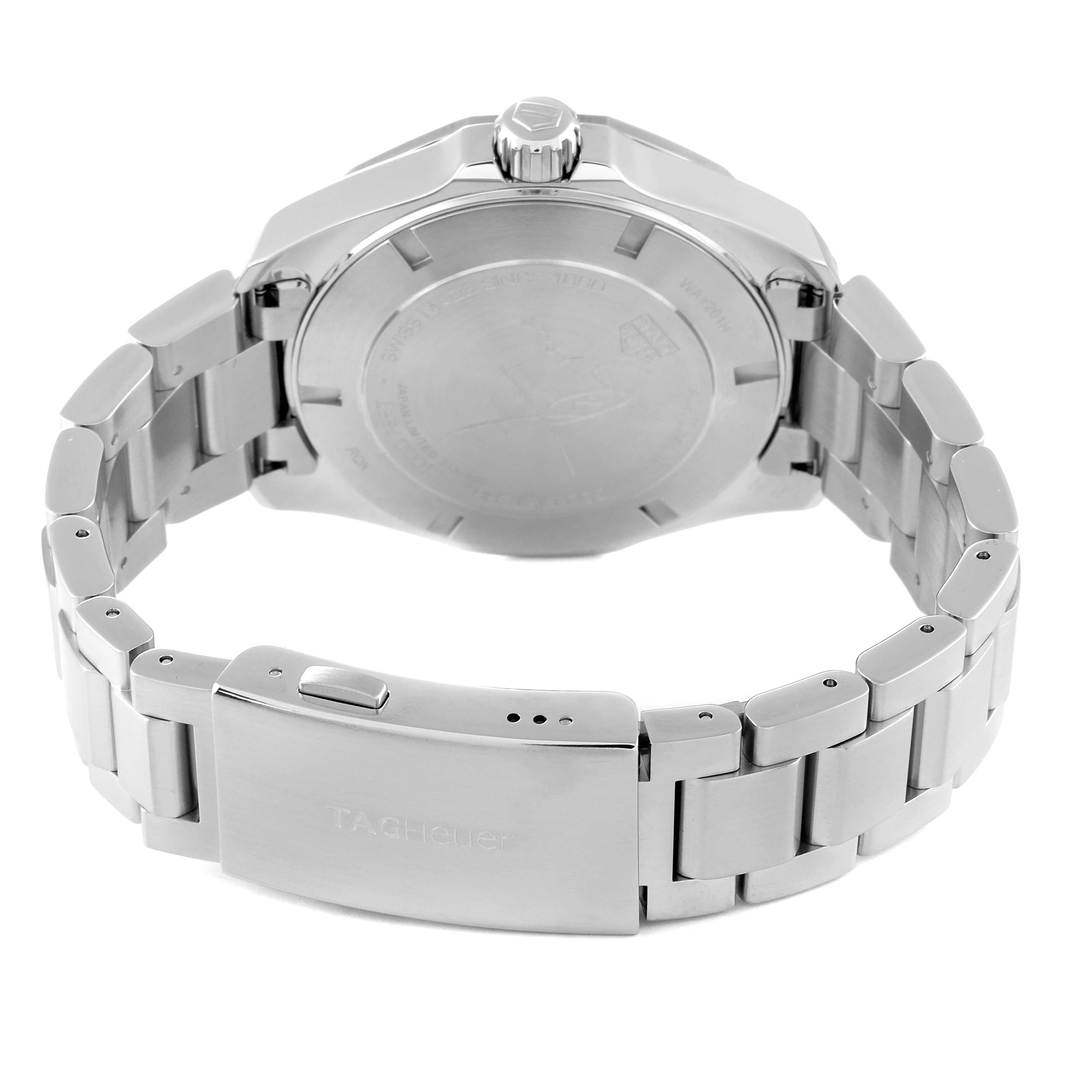The image shows the back of a Tag Heuer Aquaracer watch, including the case back, crown, and bracelet clasp.