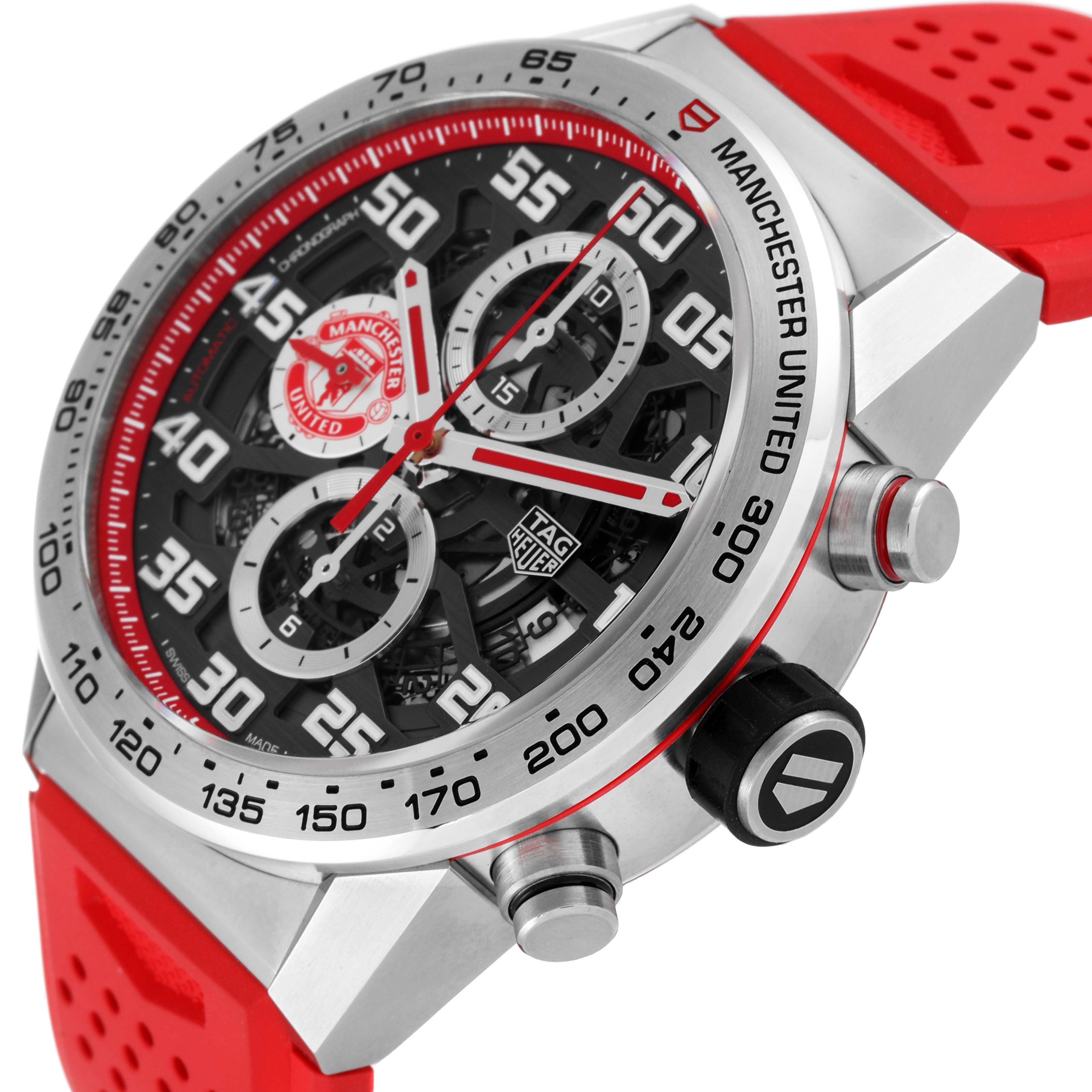 The image shows a close-up side angle of a Tag Heuer Carrera watch with Manchester United branding and a red strap.