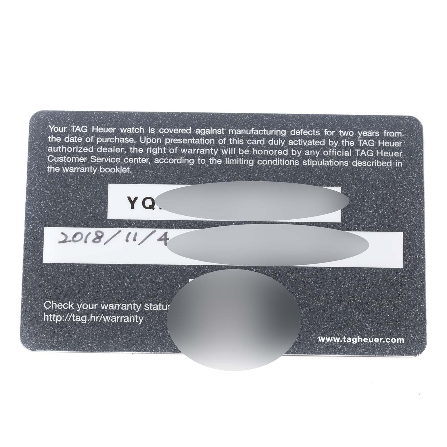 The image shows a warranty card for the Tag Heuer Carrera model watch from a top-down angle.