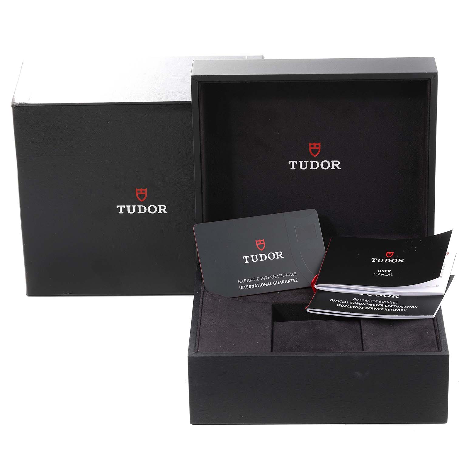 The image shows the packaging accessories of the Tudor Heritage Black Bay 79833MN Men
s Stainless Steel Black Dial 79833MN Men
s Stainless Steel Black Dial, including the box and documentation.
