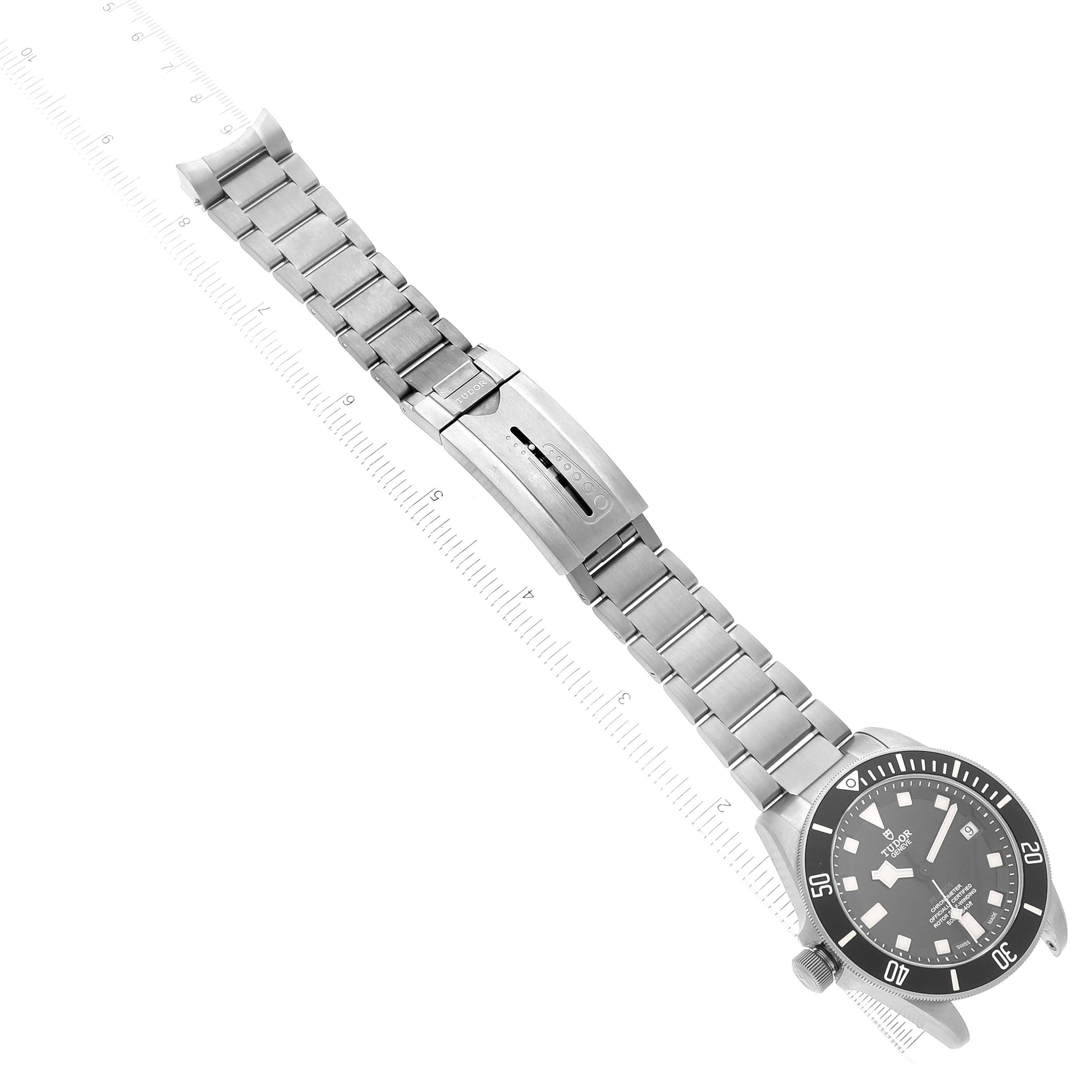 The image shows the Tudor Pelagos 25610TNL Men
s Titanium Black Dial 25610TNL Men
s Titanium Black Dial watch from an overhead angle, featuring its face, bracelet, and clasp.