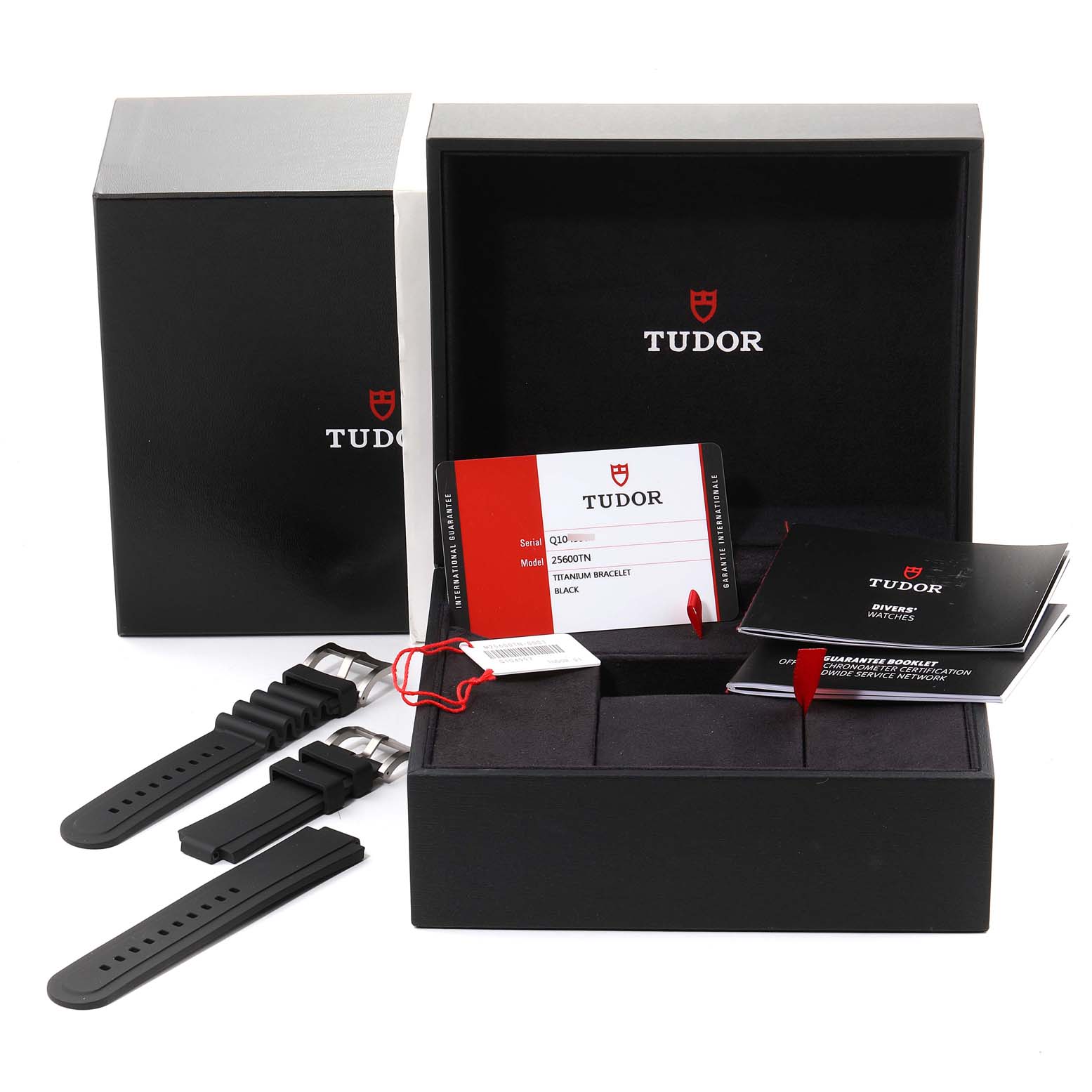 This image shows the packaging and accessories of a Tudor Pelagos 25500TN Men's Titanium Black Dial 25500TN Men's Titanium Black Dial watch, including a black box, warranty card, manuals, and extra straps.