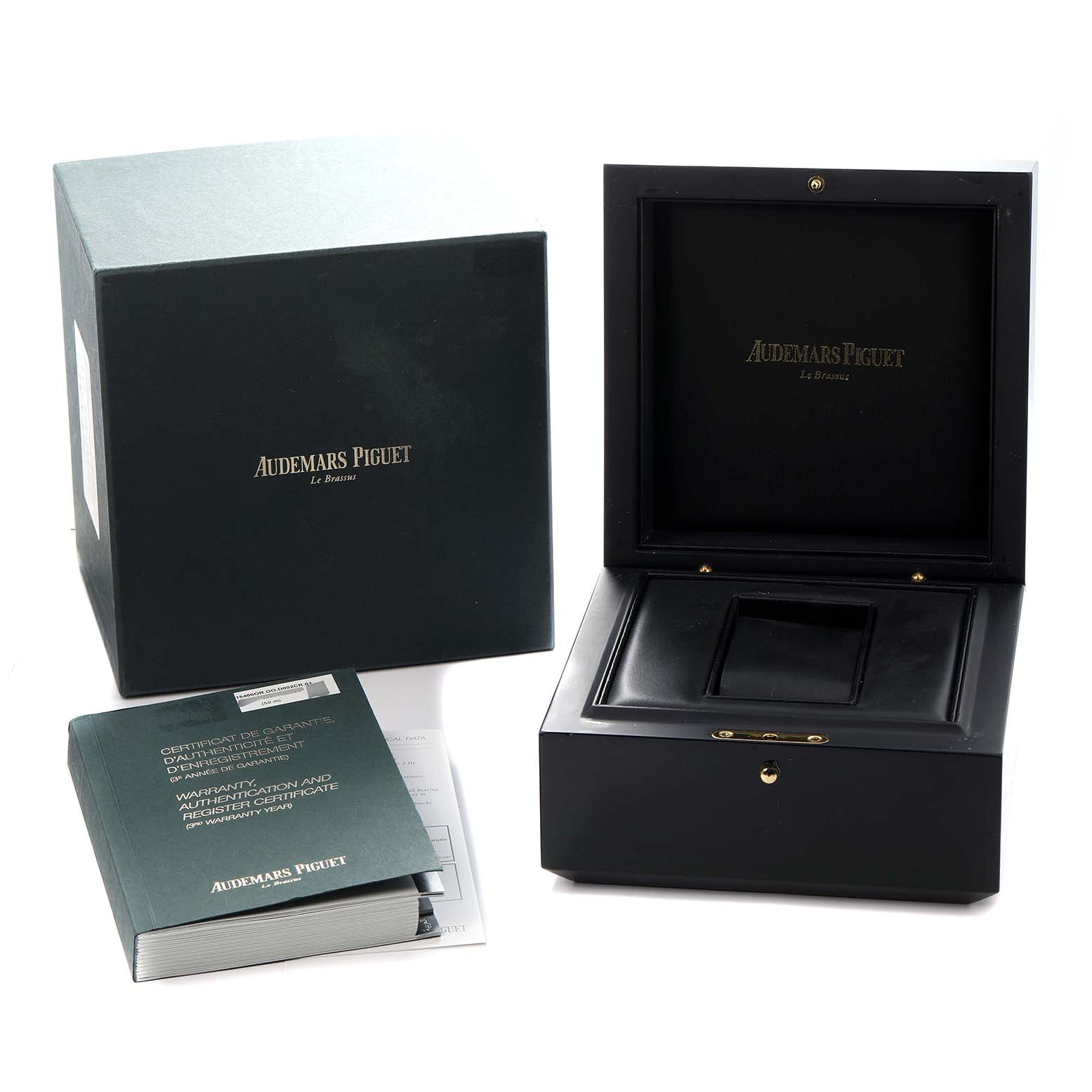 The image shows the packaging and accessories for a Royal Oak model by Audemars Piguet, including the box, outer case, and documentation.