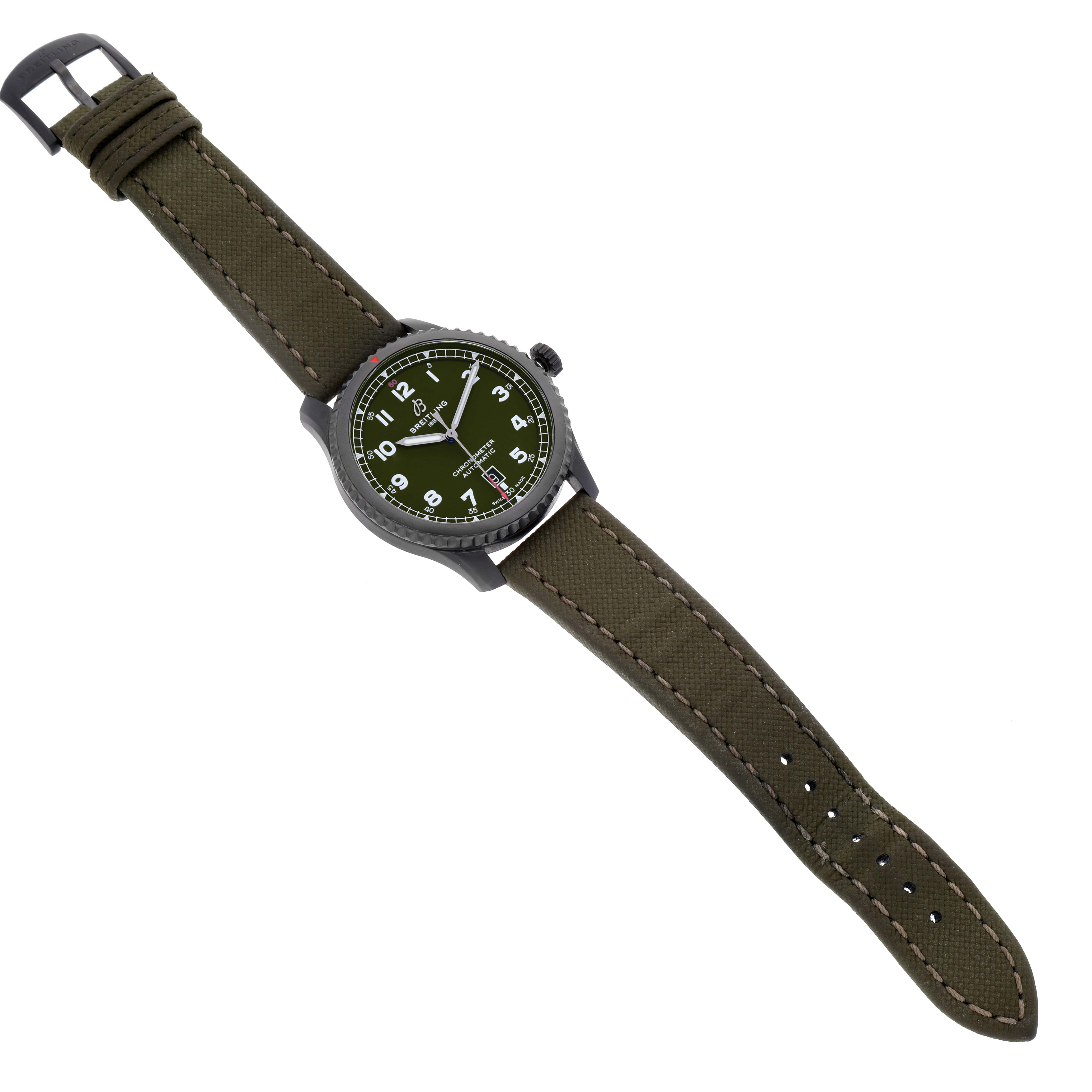 The Breitling Navitimer watch is shown from a top-down angle, displaying its green dial, case, and olive green strap.