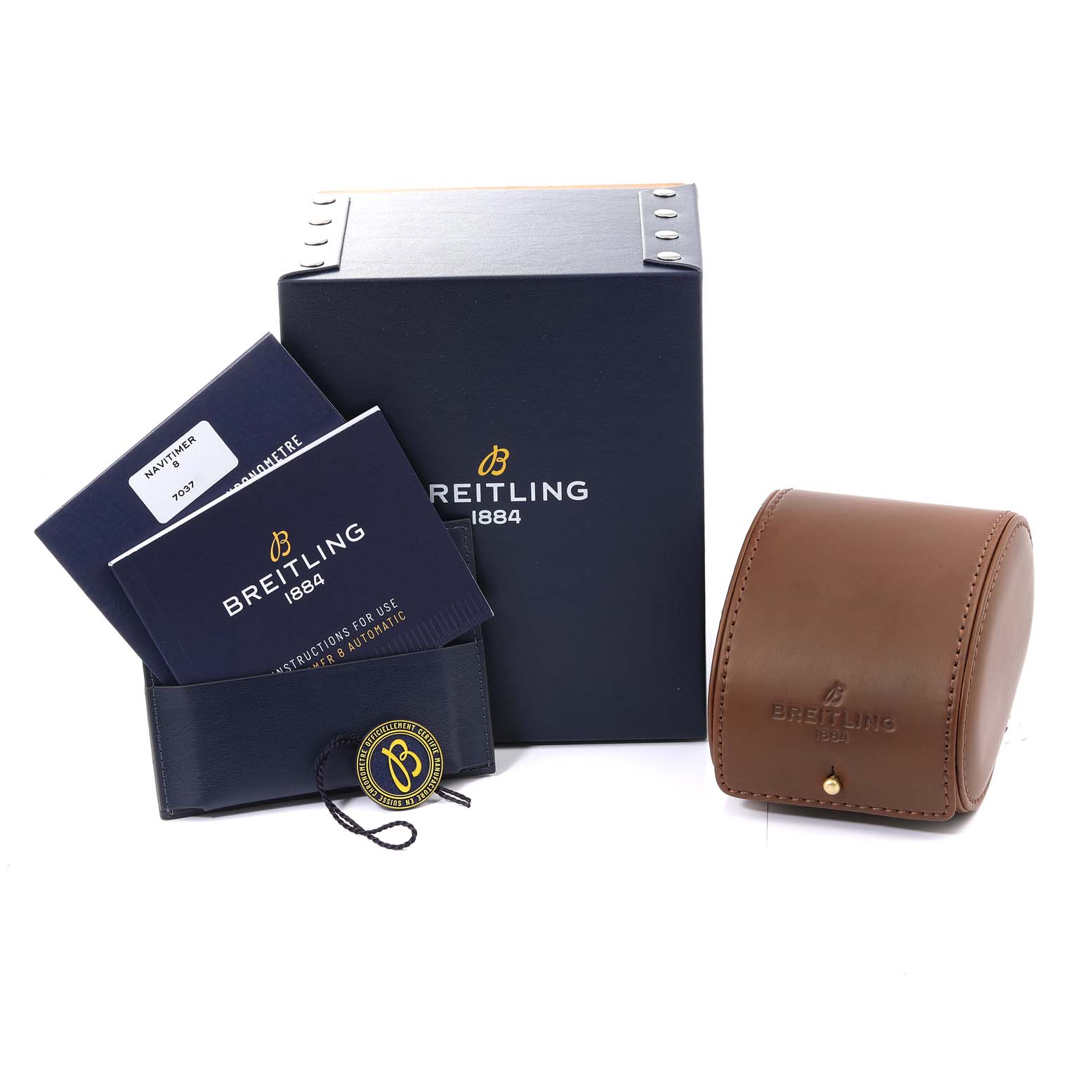 This image of the Breitling Navitimer watch shows the packaging, instruction booklets, and a leather watch case.