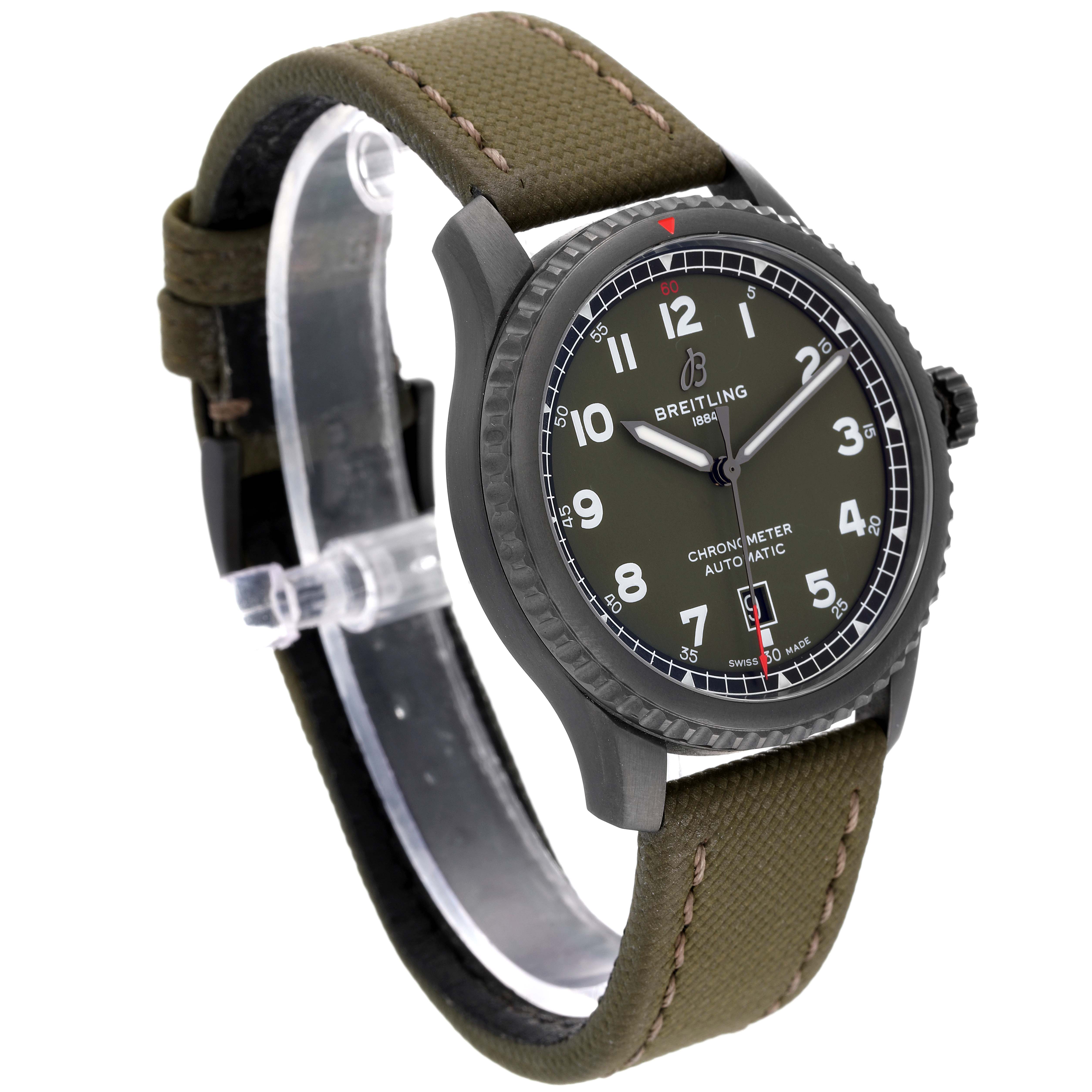 The image shows a Breitling Navitimer watch at a slight angle, highlighting its face, olive strap, and bezel.