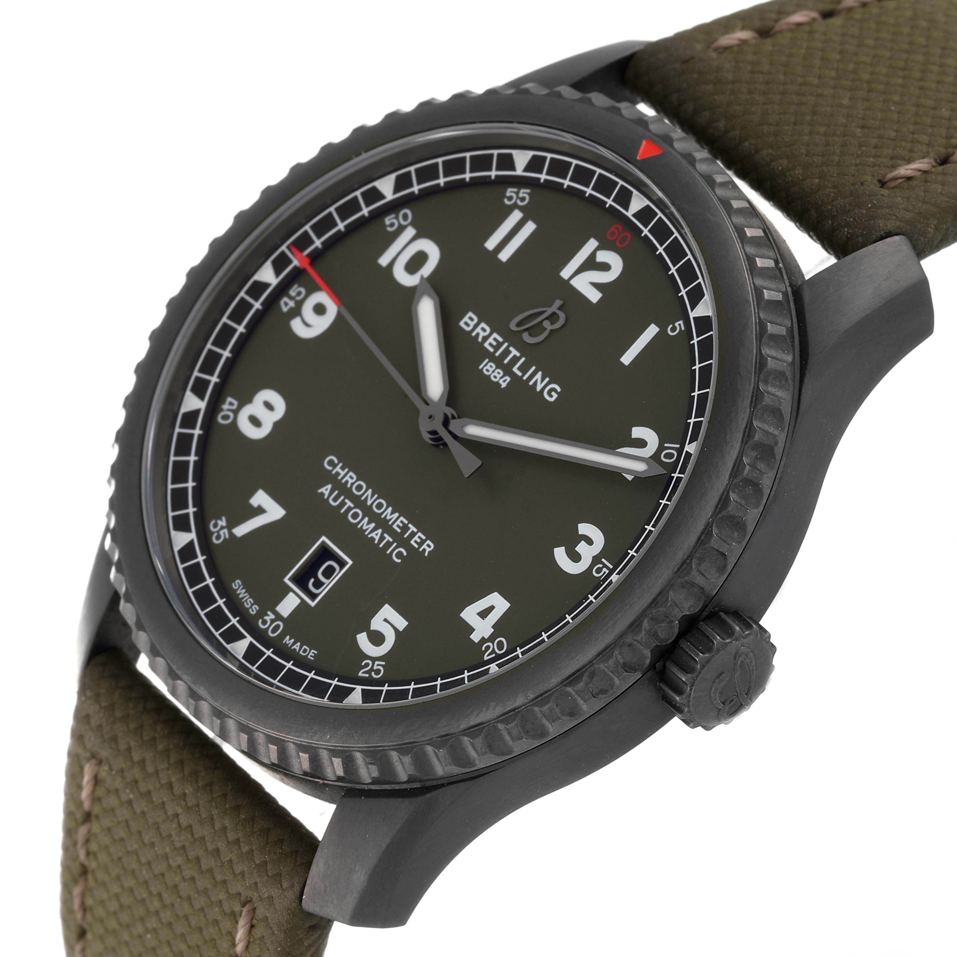 This image shows a close-up angle of the dial, bezel, and crown of a Breitling Navitimer watch with a green strap.