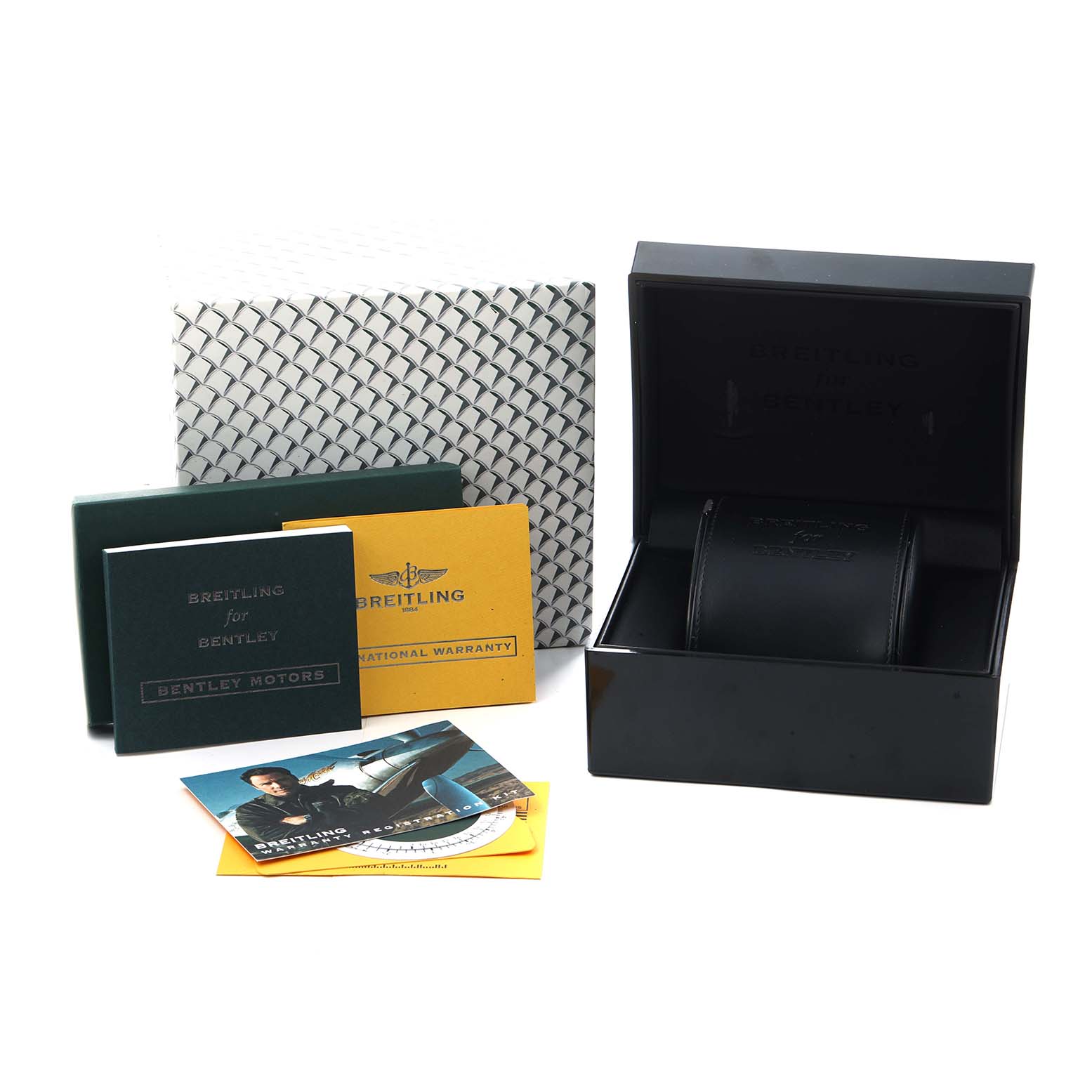 The image shows a Breitling for Bentley watch box, warranty cards, and manuals from a top angle.