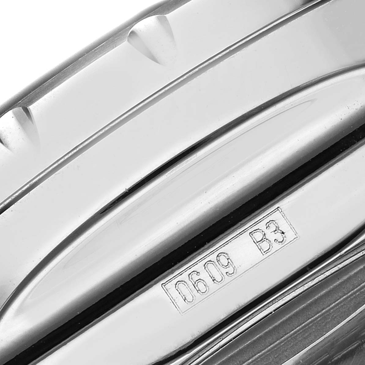 The image shows a side view of the bezel on the Breitling Bentley A25365 Men
s Stainless Steel Blue Dial watch, focusing on engraved details.