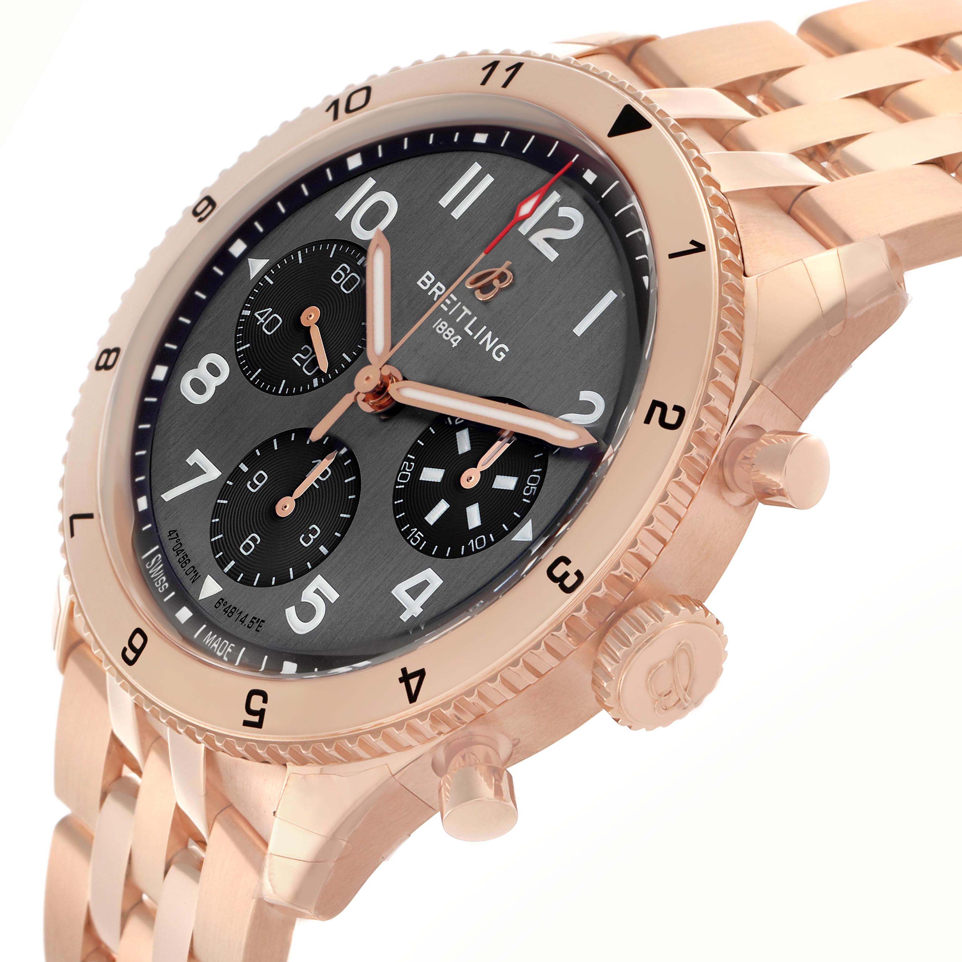 The Breitling Aviator R23380 Men
s Rose Gold Grey Dial watch is shown at an angled side view, highlighting the round face, bezel, subdials, and part of the bracelet.