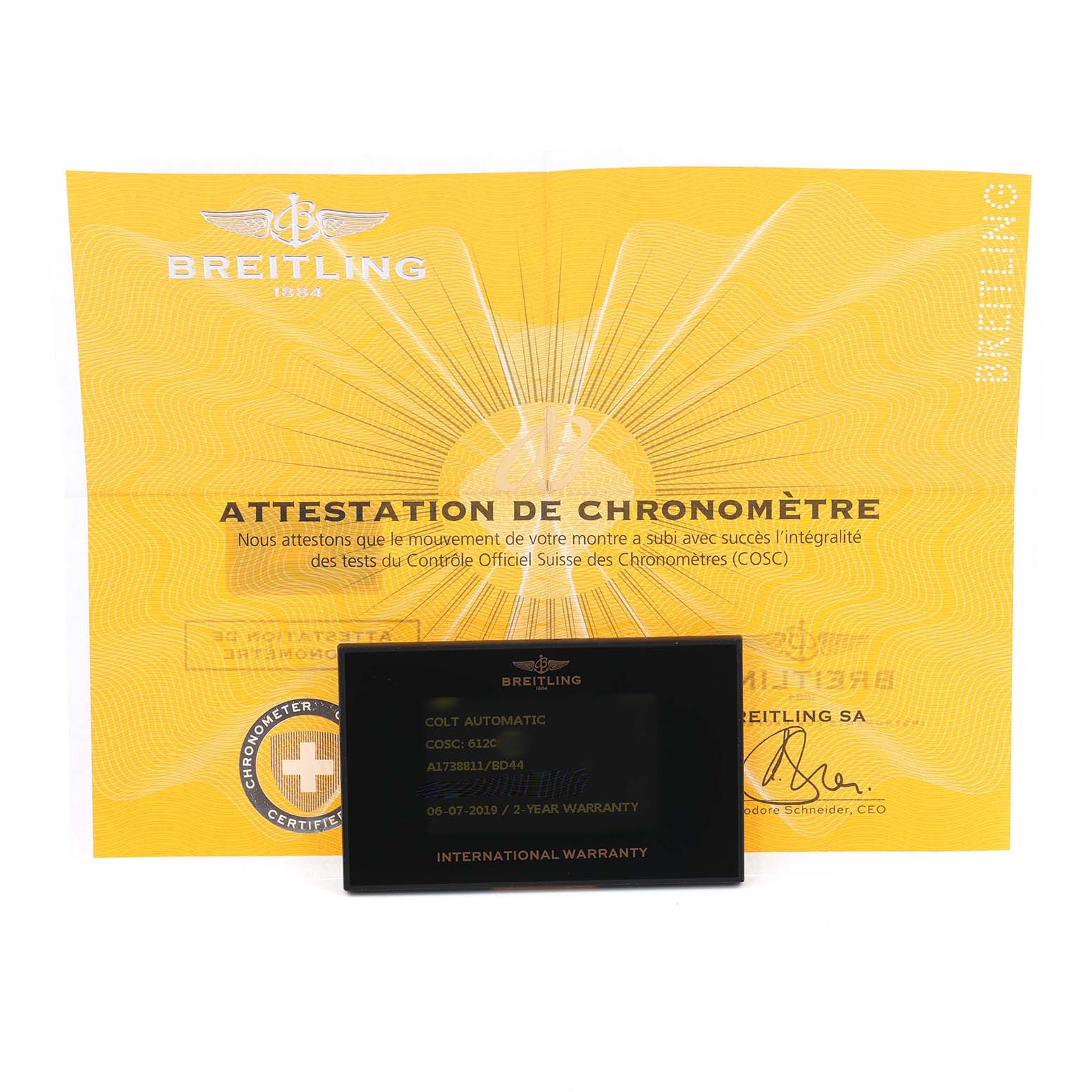 The image shows the Breitling Colt A17388 Men
s Stainless Steel Black Dial model warranty card and chronometer certificate from a front angle.