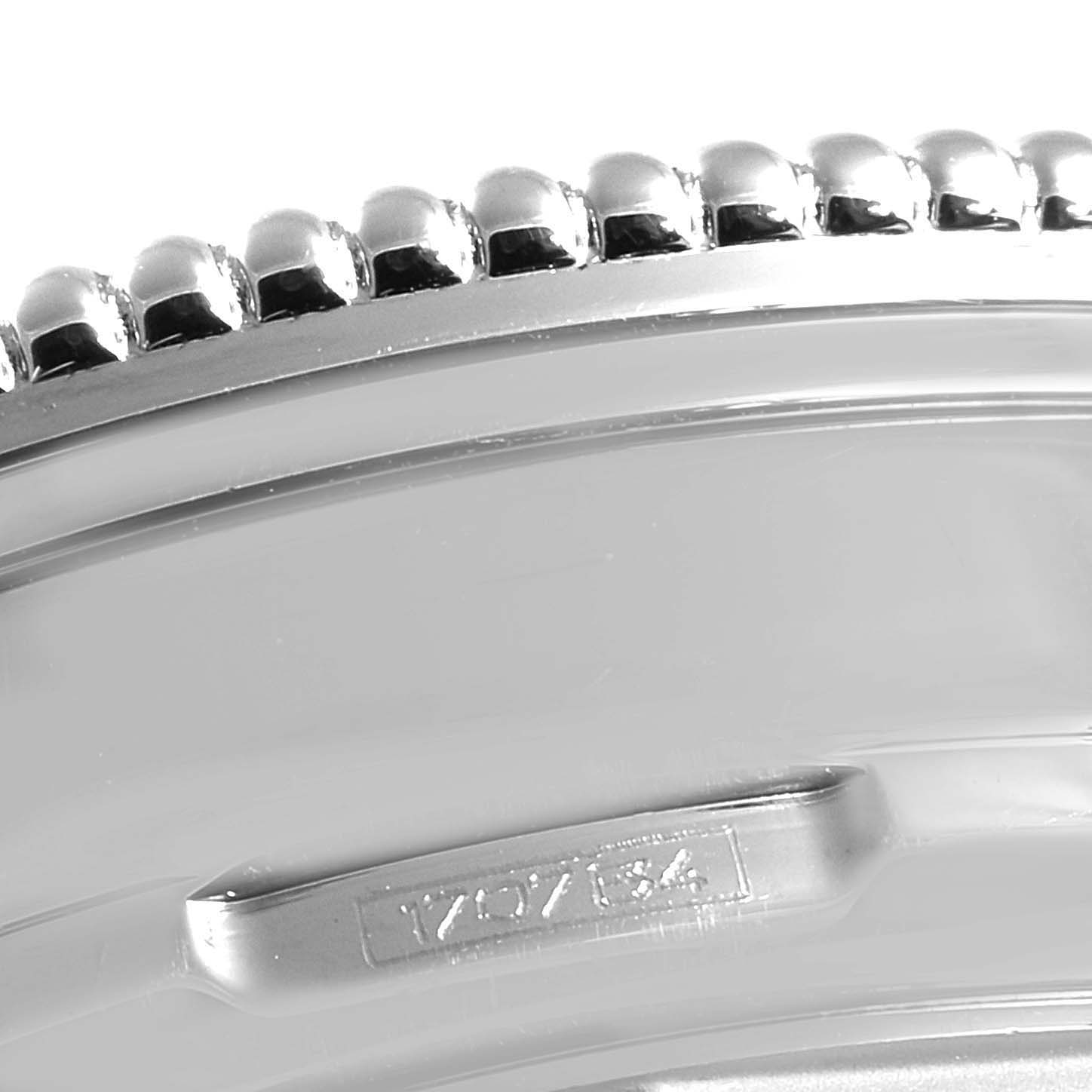 The image shows a close-up of the bezel and part of the case edge of a Breitling Navitimer A19350 Men's Stainless Steel Silver Dial A19350 Men's Stainless Steel Silver Dial watch.
