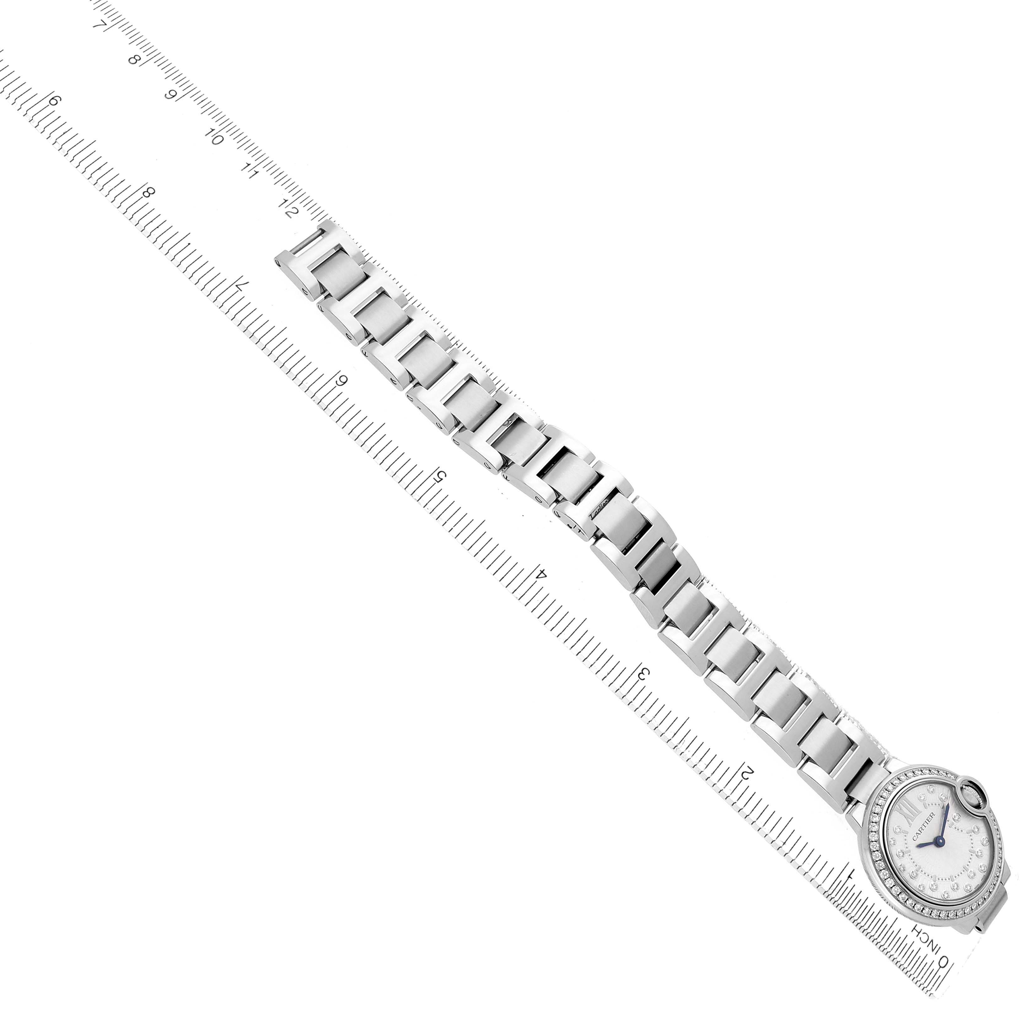 The Cartier Ballon Bleu W4BB0034 Women's Stainless Steel Silver Dial watch is pictured top-down, showing the entire bracelet and face, alongside a ruler for scale.