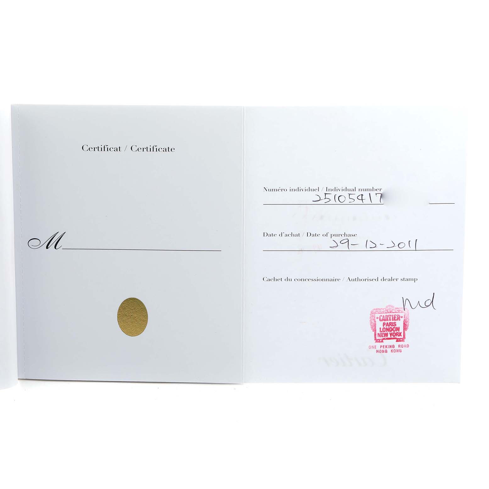 The image shows an open certificate or warranty card for the Cartier Roadster W62025V3 Men
s Stainless Steel Silver Dial watch, featuring purchase details and dealer stamp.