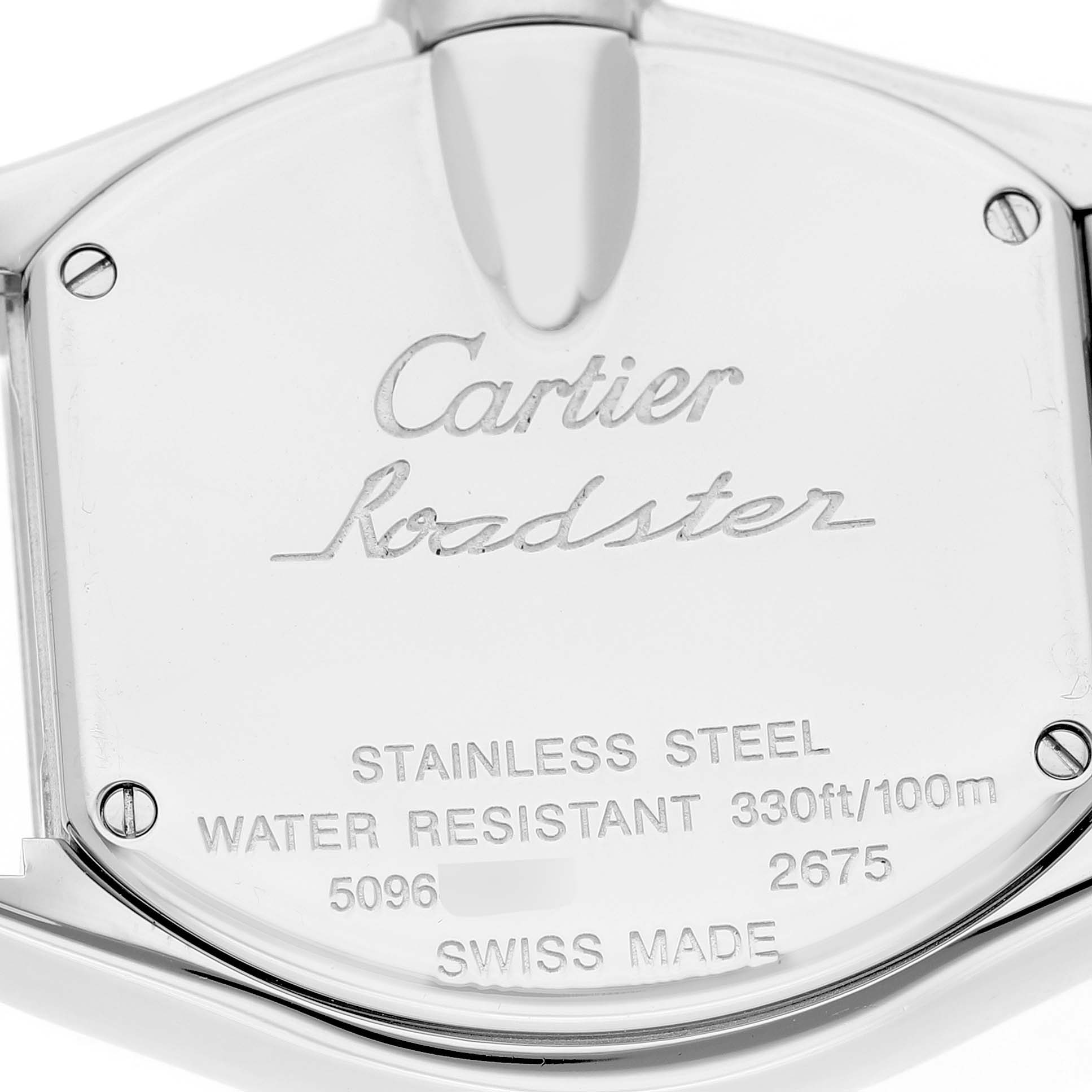 The image shows the back of a Cartier Roadster W62017V3 Women's Stainless Steel Pink Dial watch, featuring engravings of model details and brand information.