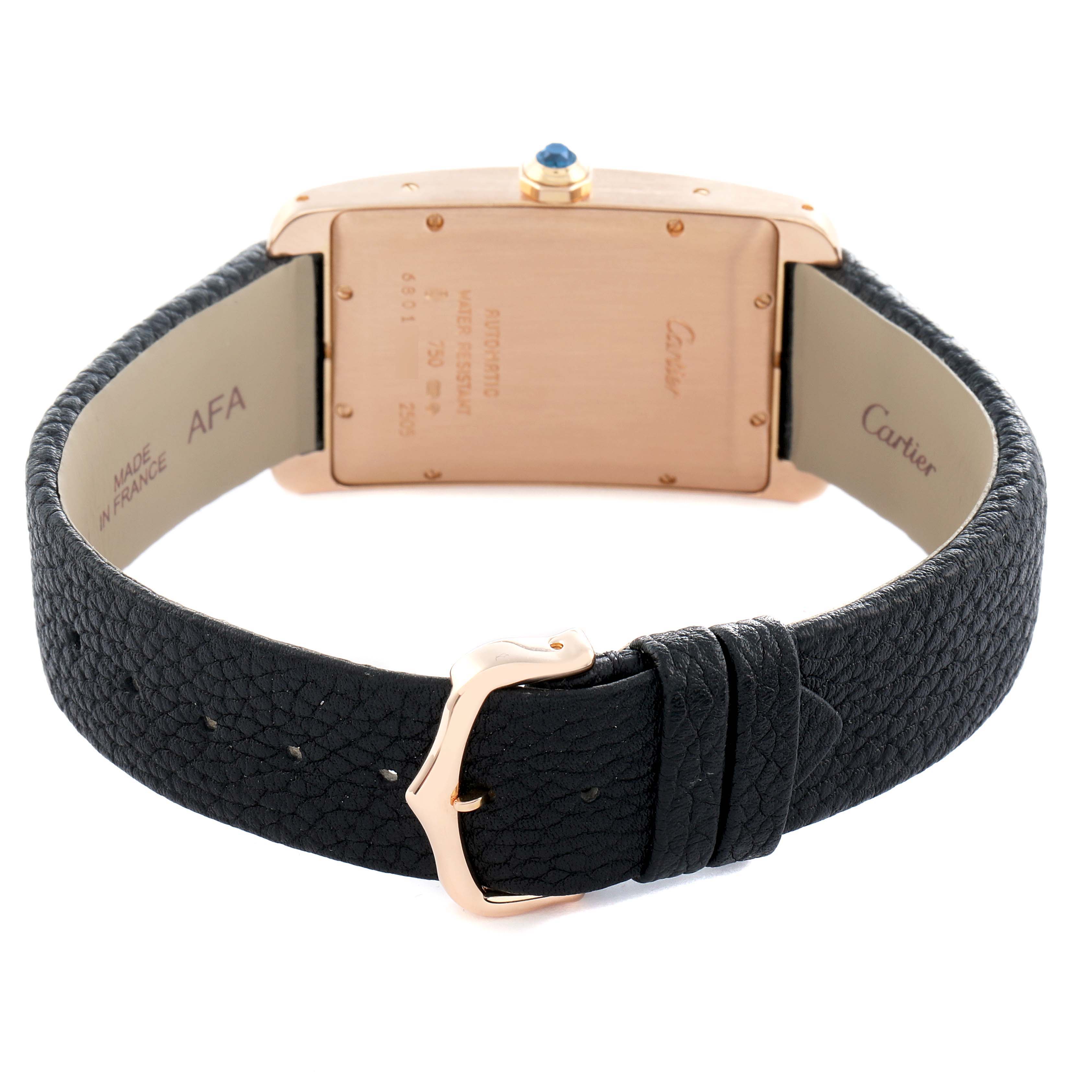 The Cartier Tank Américaine watch is shown from the back, highlighting the case, buckle, and leather strap.