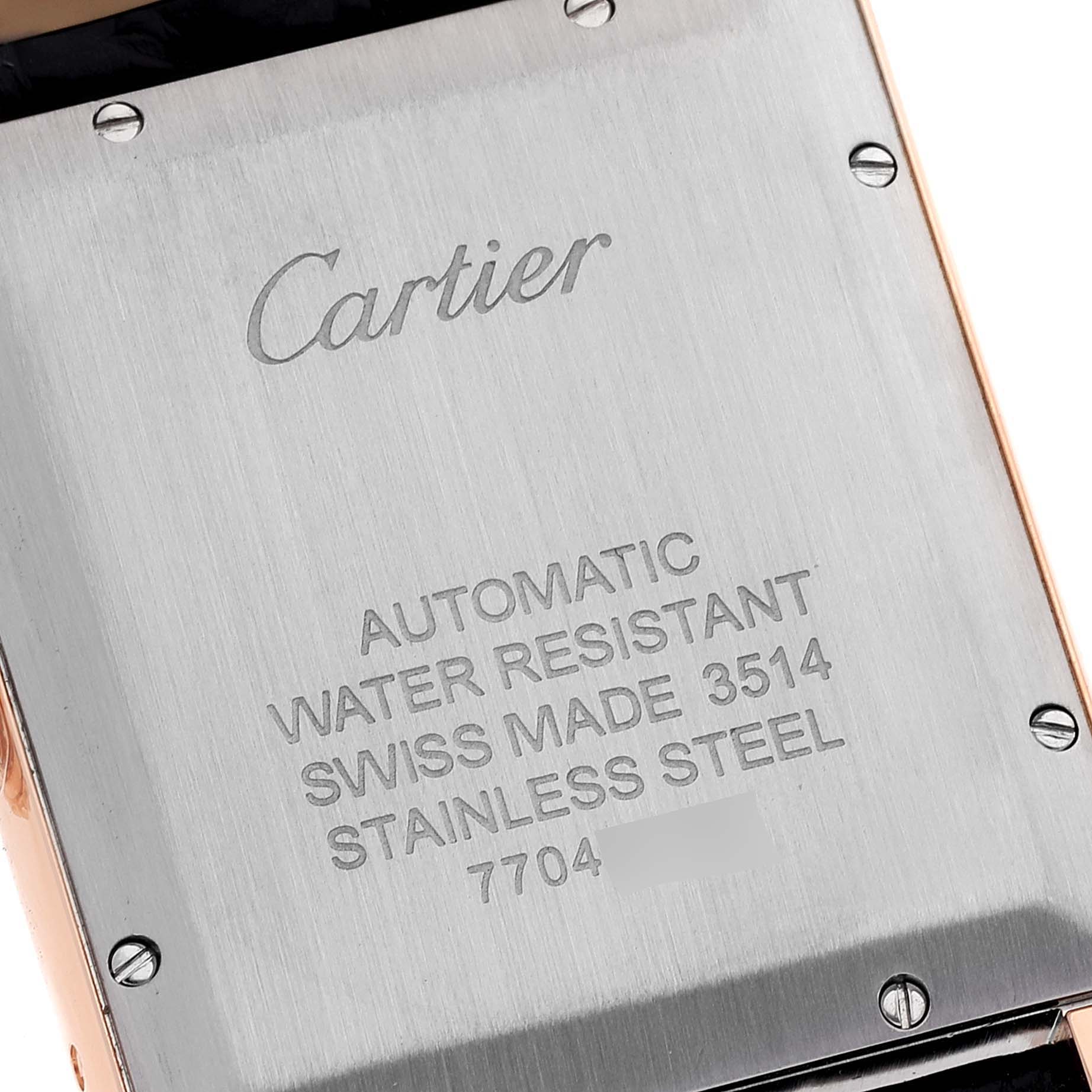 The image shows the back case of a Cartier Tank Solo W5200026 Men's Rose Gold Silver Dial W5200026 Men's Rose Gold Silver Dial watch, displaying engravings and screws.