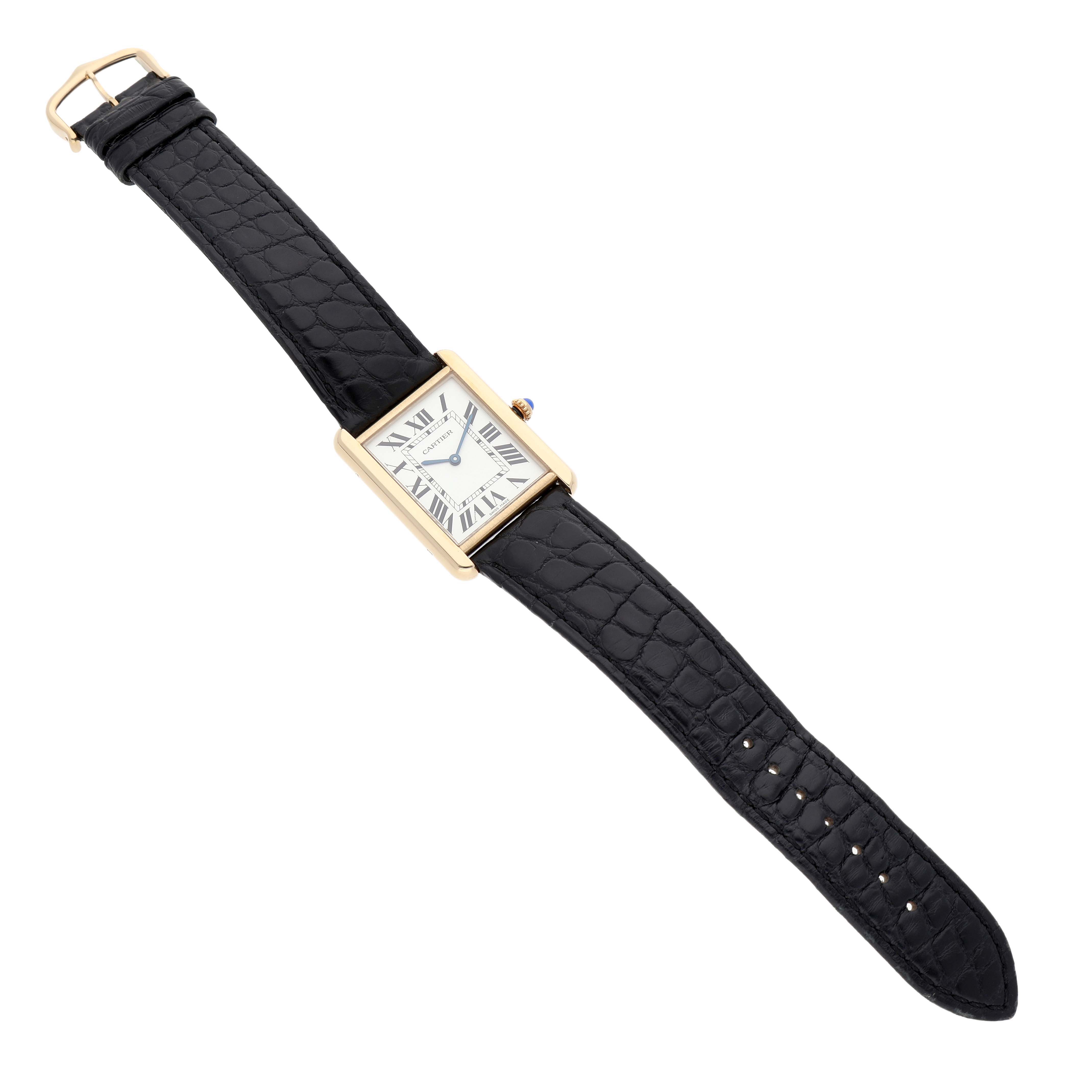 The Cartier Tank Solo W1018855 Men's Steel and Gold (two tone) Silver Dial watch is shown from a top view, displaying its rectangular face, black strap, and gold case.