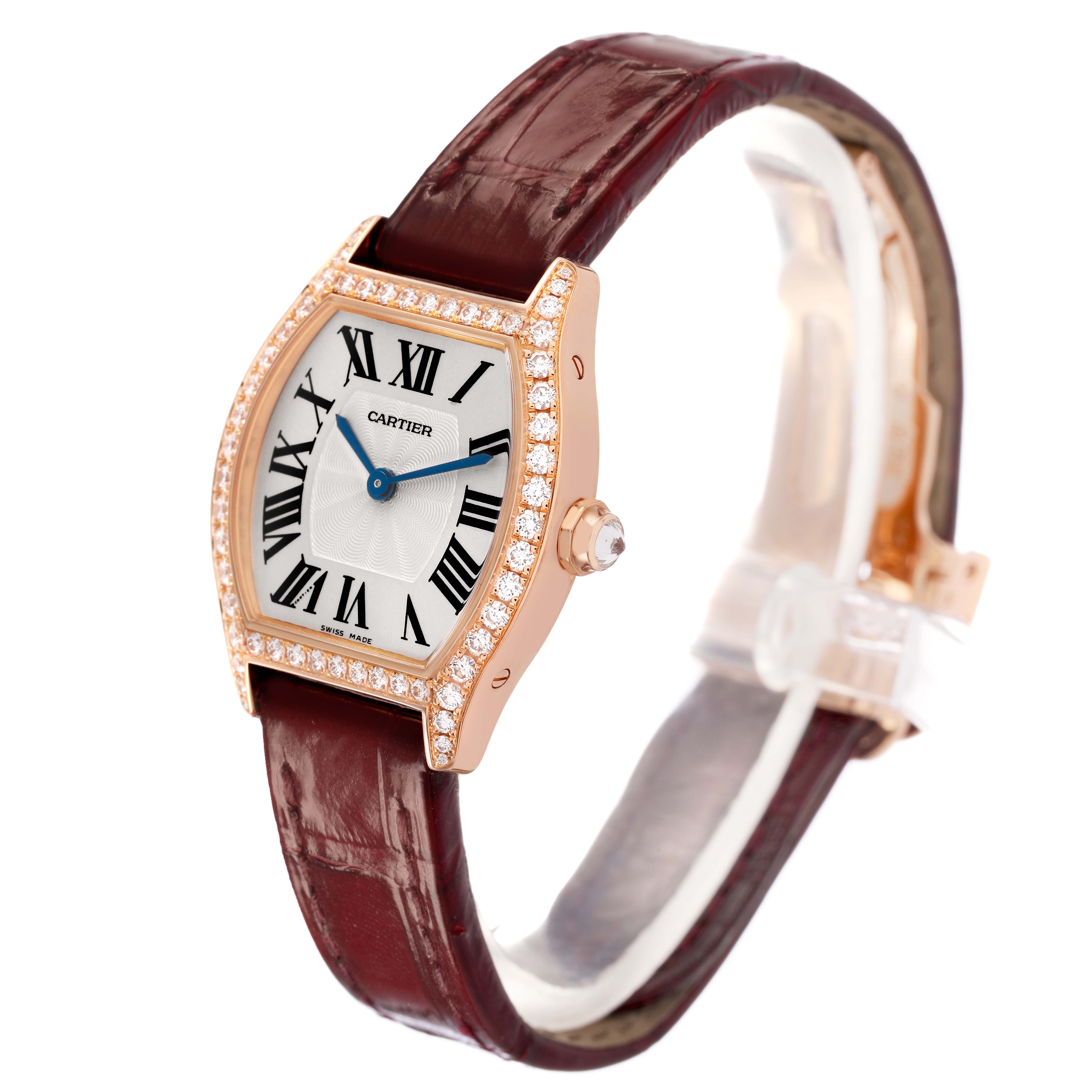The Cartier Tortue WA501010 Women's Rose Gold Silver Dial watch is shown at a slight angle, displaying its face, diamond-studded bezel, crown, and leather strap.