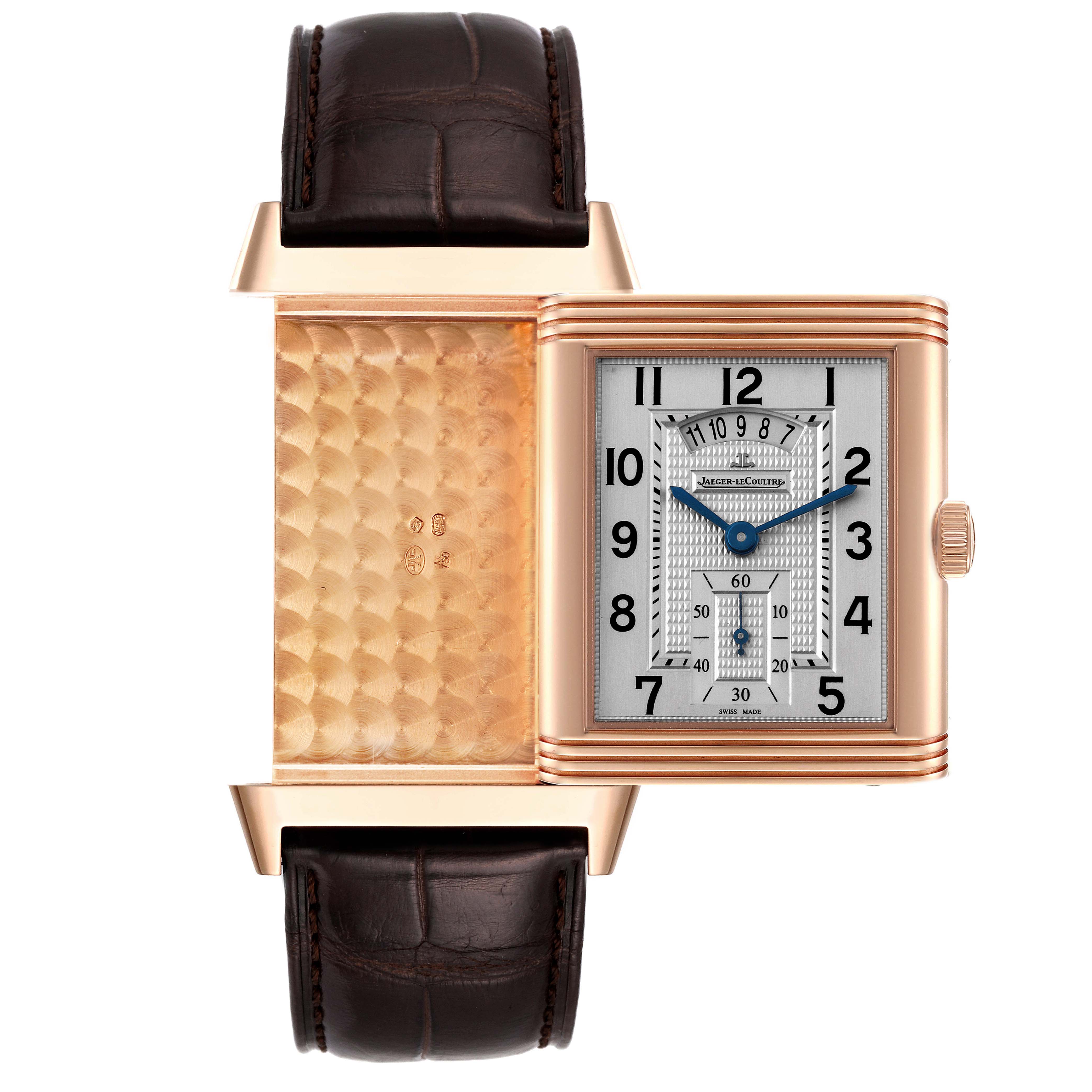 The image shows a Jaeger LeCoultre Reverso Q3742521 Men
s Rose Gold Silver Dial Q3742521 Men
s Rose Gold Silver Dial watch with its case swiveled open to reveal the inner engraved design and the face.